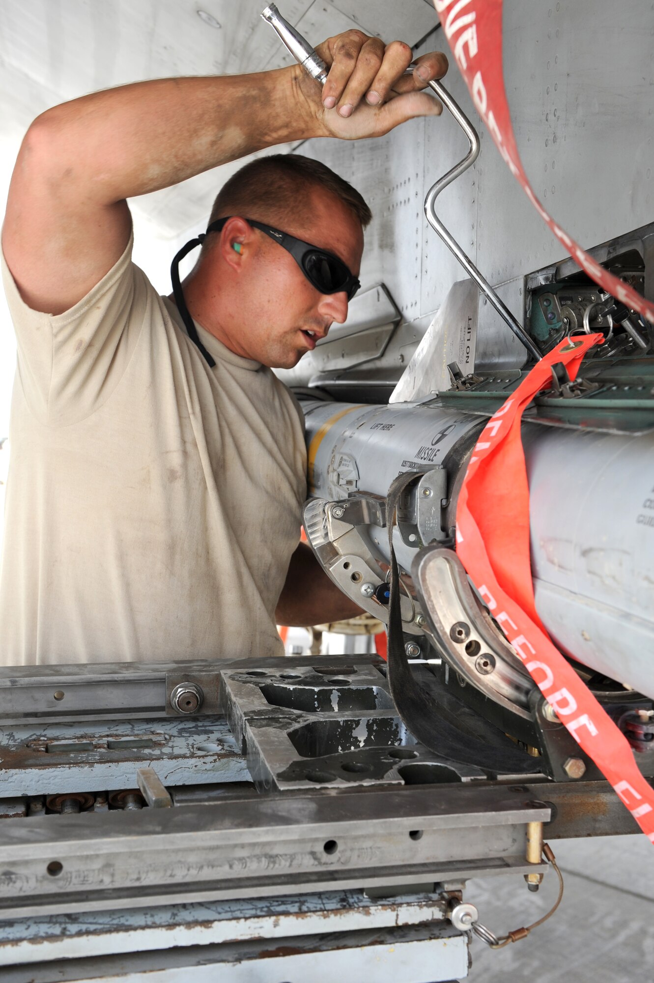 SOUTHWEST ASIA - U.S. Air Force Tech. Sgt. Brandon Orr, 380th Expeditionary Aircraft Maintenance Squadron weapons loader, secures a missile on a F-15C Eagle during a generation exercise Aug. 17, 2012. Orr, a New Orleans native, is deployed to the 380th Air Expeditionary Wing from the Louisiana Air National Guard. (U.S. Air Force photo/Master Sgt. Scott MacKay)