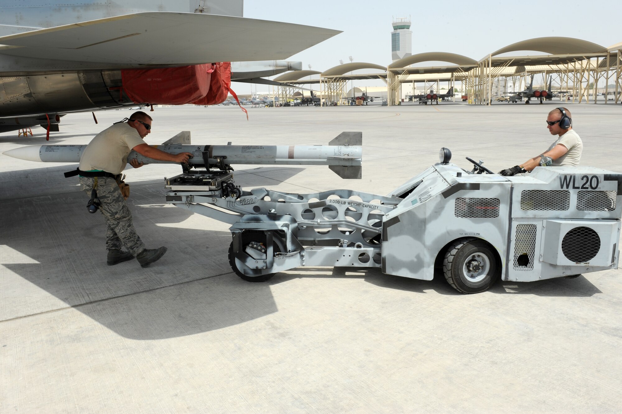 SOUTHWEST ASIA - U.S. Air Force Tech. Sgt. Brandon Orr, left, and Staff Sgt. Randy Millet, right, 380th Expeditionary Aircraft Maintenance Squadron weapons loaders, line up a missile under an F-15C Eagle  during a generation exercise Aug. 17, 2012. The generation exercise tested the wing's ability to generate aircraft sorties in the event of contingency operations. (U.S. Air Force photo/Master Sgt. Scott MacKay)
