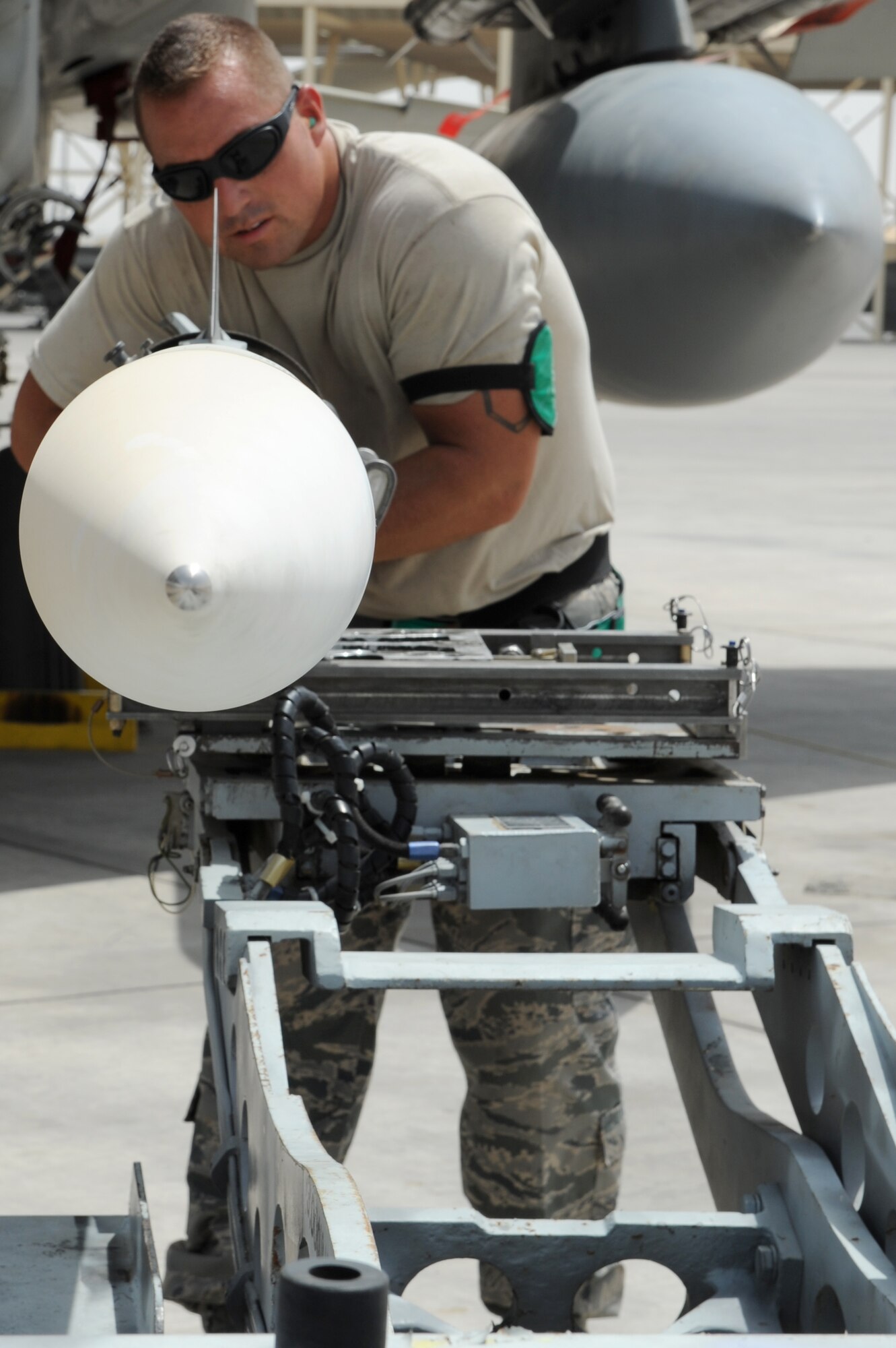 SOUTHWEST ASIA - U.S. Air Force Tech. Sgt. Brandon Orr, 380th Expeditionary Aircraft Maintenance Squadron weapons loader, lines up a missile to be loaded on a F-15C Eagle during a generation exercise Aug. 17, 2012. The generation exercise tested the wing's ability to generate aircraft sorties in the event of contingency operations. (U.S. Air Force photo/Master Sgt. Scott MacKay)