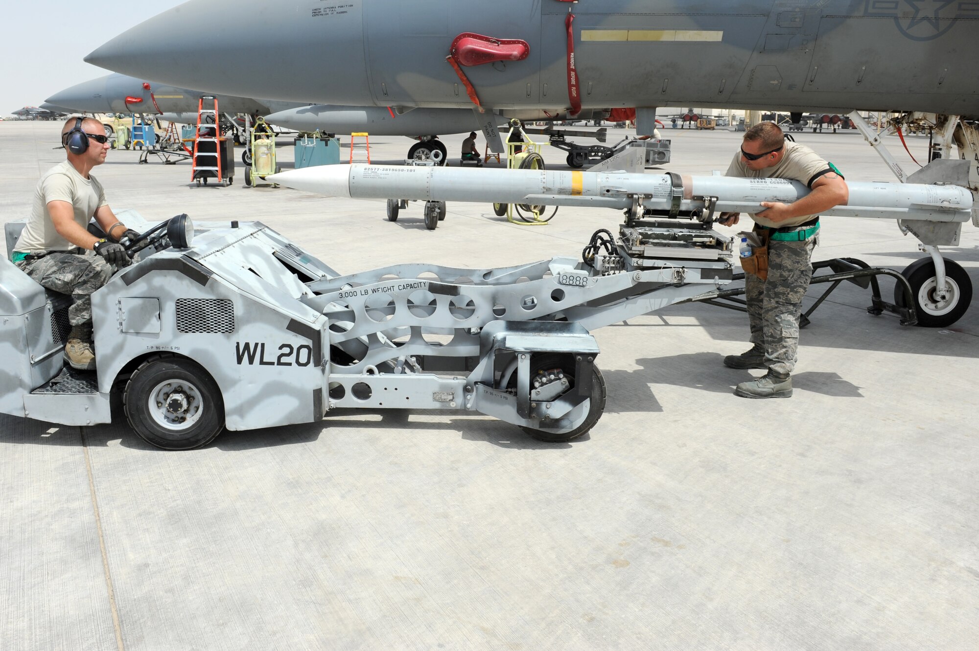 SOUTHWEST ASIA - U.S. Air Force Tech. Sgt. Brandon Orr, right, and Staff Sgt. Randy Millet, left, 380th Expeditionary Aircraft Maintenance Squadron weapons loaders, line up a missile during a generation exercise Aug. 17, 2012. The generation exercise tested the wing's ability to generate aircraft sorties in the event of contingency operations. (U.S. Air Force photo/Master Sgt. Scott MacKay)