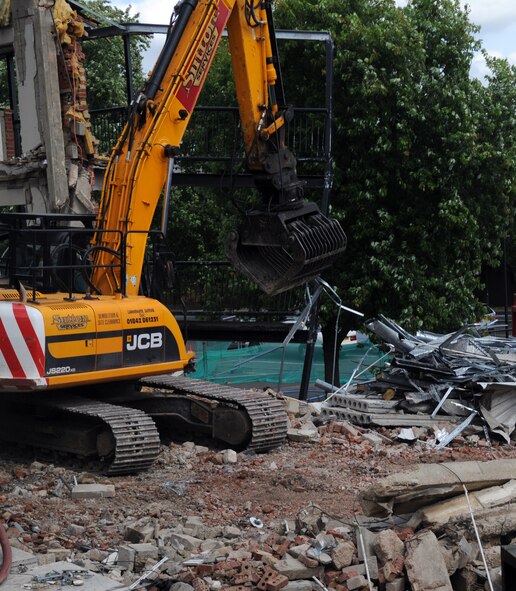 RAF MILDENHALL, England – Rob Saunvers, JCB Tracked Excavator JS220 Long Reach operator and contractor, separates metal from debris during the demolition of Dorm 214 August 17, 2012, at RAF Mildenhall. After Dorm 214 is demolished, all the metal gathered will be recycled. (U.S. Air Force photo/Senior Airman Rachel Waller)    