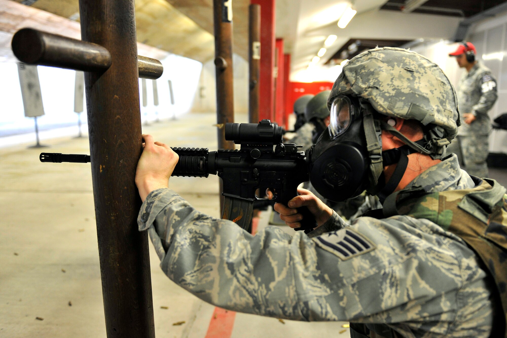 Staff Sgt. Brett Thomason, 1st Combat Communication Squadron, uses the M68 sight while performing the gas mask shooting qualification at Vogelweh Military Complex, Germany, Aug. 10, 2012.  The 569th Combat Arms Training and Maintenance has 15 assigned instructors and our responsible for the entire Kaiserslautern Military Community area and eight geographical separated units. (U.S. Air Force photo/Senior Airman Chris Willis)