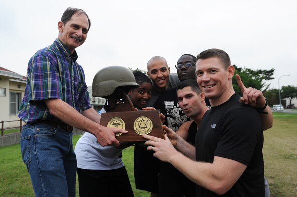 U.S. Air Force Airmen from the 35th Aerospace Medical Squadron pose for a picture with Col. Terry Haske, left, 35th Medical Group commander, after winning the 35 MDG warrior medic challenge at Misawa Air Base, Japan, Aug. 17, 2012. Out of all of the squadrons participating in the challenge, the 35 AMDS finished at the top of the pack and walked away with the trophy. The challenge boosted morale by promoting fitness and teamwork within the squadrons. (U.S. Air Force photo/Airman 1st Class Kia Atkins) 
