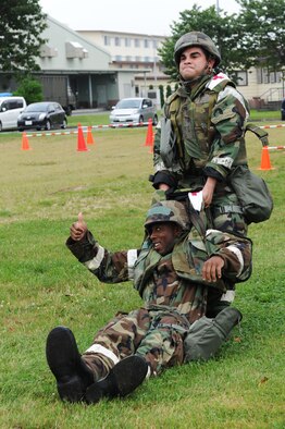 U.S. Air Force Staff Sgt. Kristian Abarca, 35th Medical Support Squadron medical information systems technician, drags Airman 1st Class Kelvin Davis, 35 MDSS unit deployment manager, during a 35th Medical Group challenge at Misawa Air Base, Japan, Aug. 17, 2012. Members from four medical squadrons within the 35 MDG took part in this timed challenge to improve morale and showcase which squadron executed fitness dominance. (U.S. Air Force photo/Airman 1st Class Kia Atkins) 
