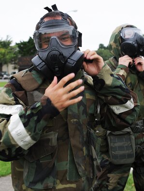U.S. Air Force Airman 1st Class Donald Belec, 35th Medical Support Squadron outpatient records technician, dons his gas mask during a 35th Medical Group warrior medic challenge at Misawa Air Base, Japan, Aug. 17, 2012. Members from four medical squadrons in the 35 MDG competed against each other for a trophy and bragging rights for their units. The point of the challenge was to boost morale and showcase which squadron was physically dominant. (U.S. Air Force photo/Airman 1st Class Kia Atkins) 
