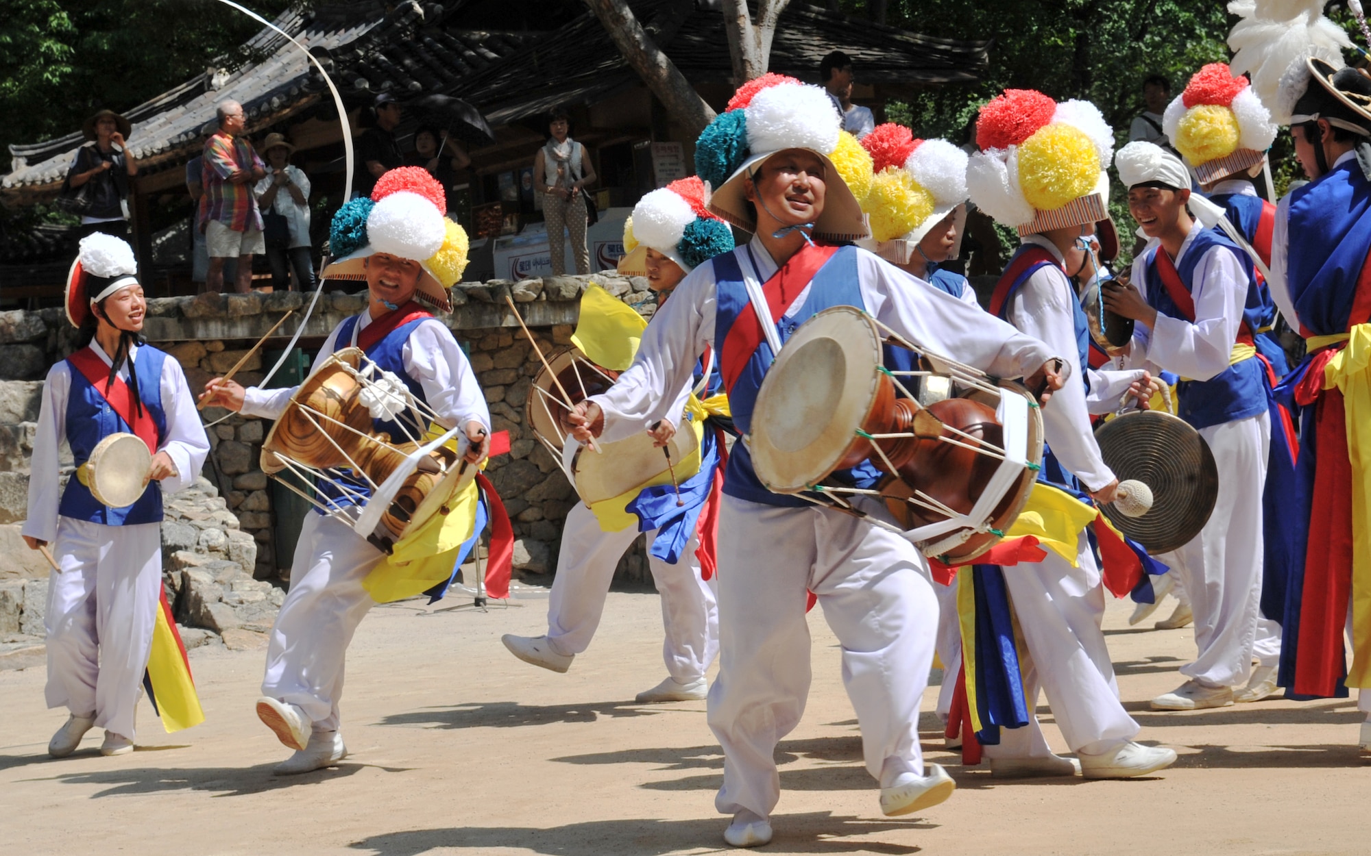 Performers sing and dance at the Korean Folk Village Aug. 17, 2012. The folk village, located eight miles outside Osan Air Base’s main gate in the heart of Yongin, offers a gateway for service members and their families into Korea’s past.  (U.S. Air Force photo/Staff Sgt. Stefanie Torres)