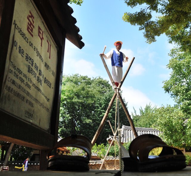 A tightrope walker performs stunts at the Korean Folk Village, Aug. 17, 2012. Throughout the day, the village comes to life with a selection of vibrant performances that give spectators a view into this ancient culture. (U.S. Air Force photo/Staff Sgt. Stefanie Torres)