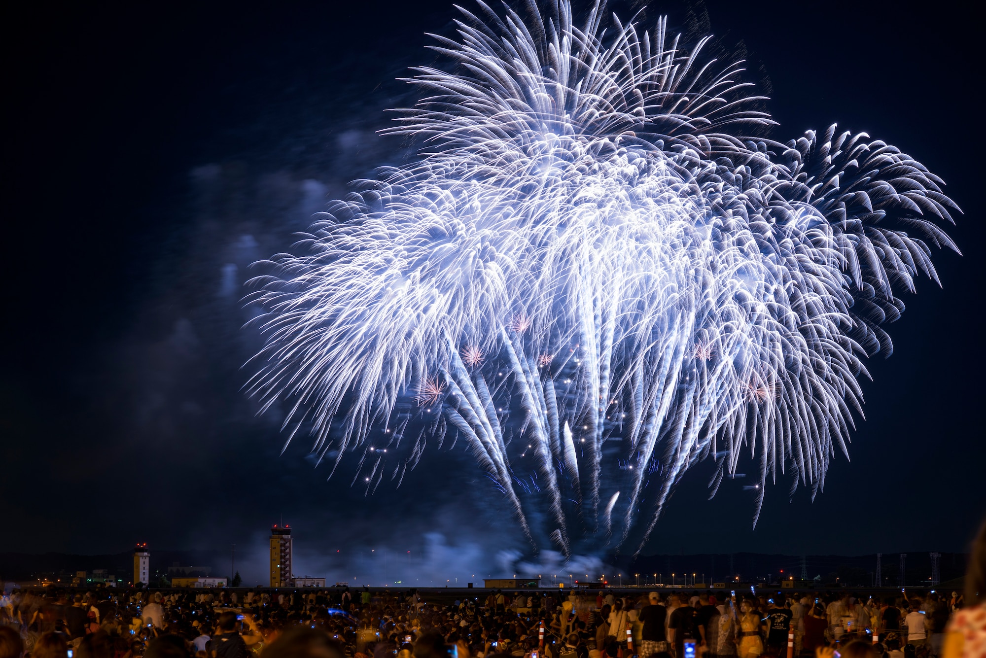 YOKOTA AIR BASE, Japan -- Fireworks burst over the flightline during the 2012 Japanese-American Friendship Festival at Yokota Air Base, Japan, Aug. 19, 2012. The festival concluded with a 25-minute fireworks display inspiring many cheers from the crowd. (U.S. Air Force photo illustration by Tech. Sgt. Samuel Morse)