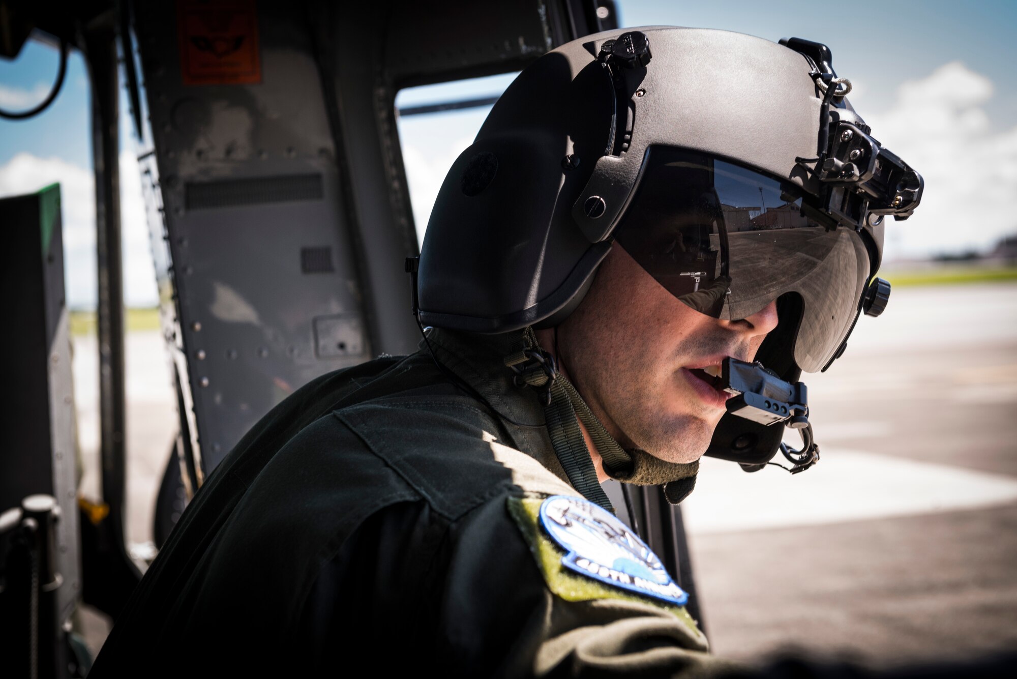 YOKOTA AIR BASE, Japan -- Staff Sgt. Andrew Schloemer, 459th Airlift Squadron flight engineer, looks out the open door of a UH-1N Huey before takeoff at the 2012 Japanese-American Friendship Festival at Yokota Air Base, Japan, Aug. 19, 2012. The UH-1N crew flew three passes over the flightline to showcase the aircraft for the crowd. (U.S. Air Force photo by Tech. Sgt. Samuel Morse)