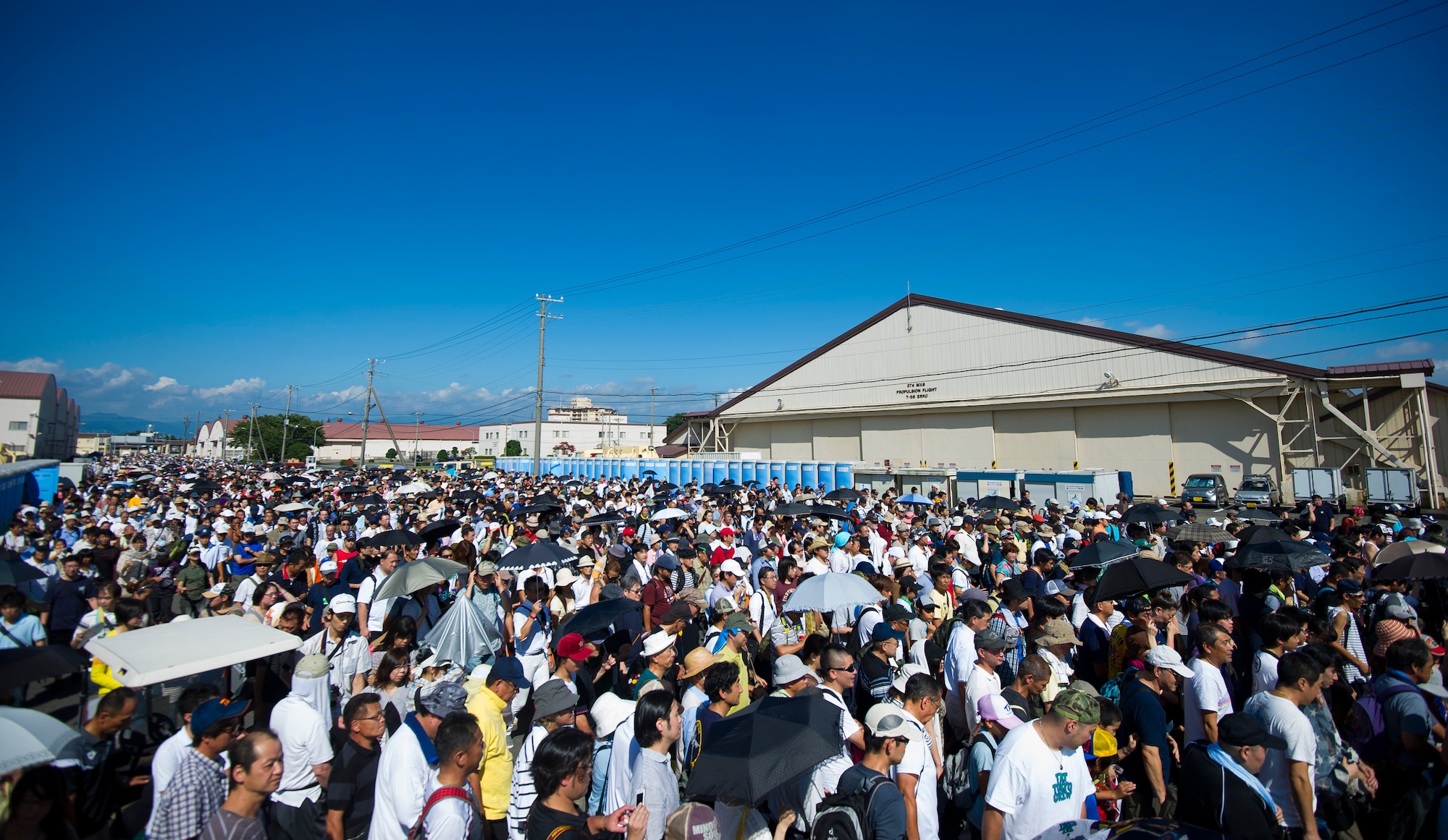 YOKOTA AIR BASE, Japan -- Thousands of Japanese patrons fill the street in front of the entrance to the flightline during the 2012 Japanese-American Friendship Festival at Yokota Air Base, on Aug. 19, 2012.  Over a span of two days, approximately 178,000 patrons attended the event. (U.S. Air Force photo by Staff Sgt. Chad C. Strohmeyer)