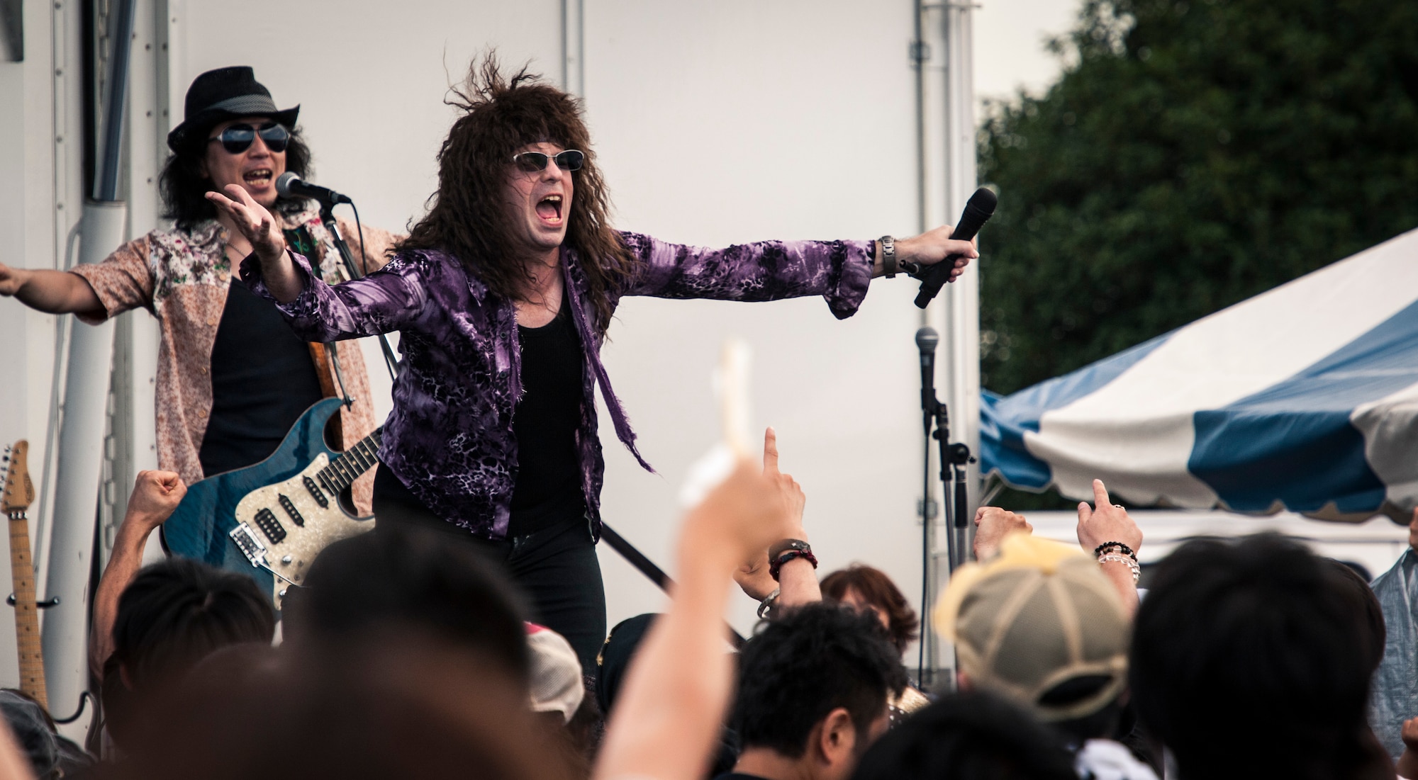 YOKOTA AIR BASE, Japan -- The lead singer of ATs 69, a Bon Jovi tribute band, works the crowd during their finale at the 2012 Japanese-American Friendship Festival at Yokota Air Base, Japan, Aug. 18, 2012. (U.S. Air Force photo by Tech. Sgt. Samuel Morse)