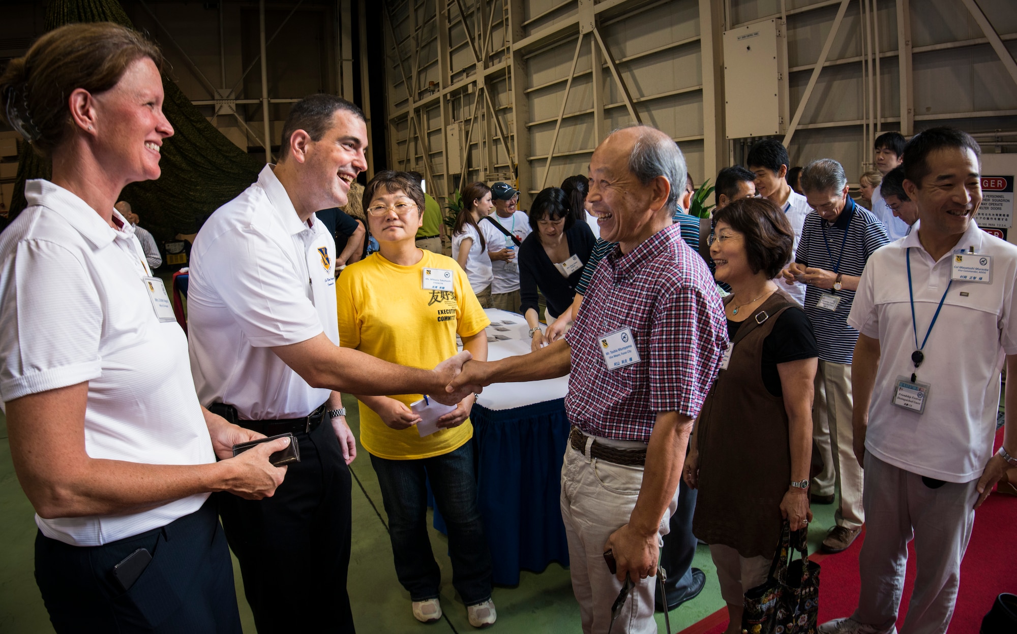 YOKOTA AIR BASE, Japan -- Col. Mark August, center-left, 374th Airlift Wing commander, shakes hands with Toshio Murayama, Vice Mayor of Fussa City, during a distinguished visitor reception on the first day of the 2012 Japanese-American Friendship Festival at Yokota Air Base, Japan, Aug. 18, 2012. Yokota welcomed approximately 178,000 visitors for the festival including local and regional dignitaries. (U.S. Air Force photo by Tech. Sgt. Samuel Morse)