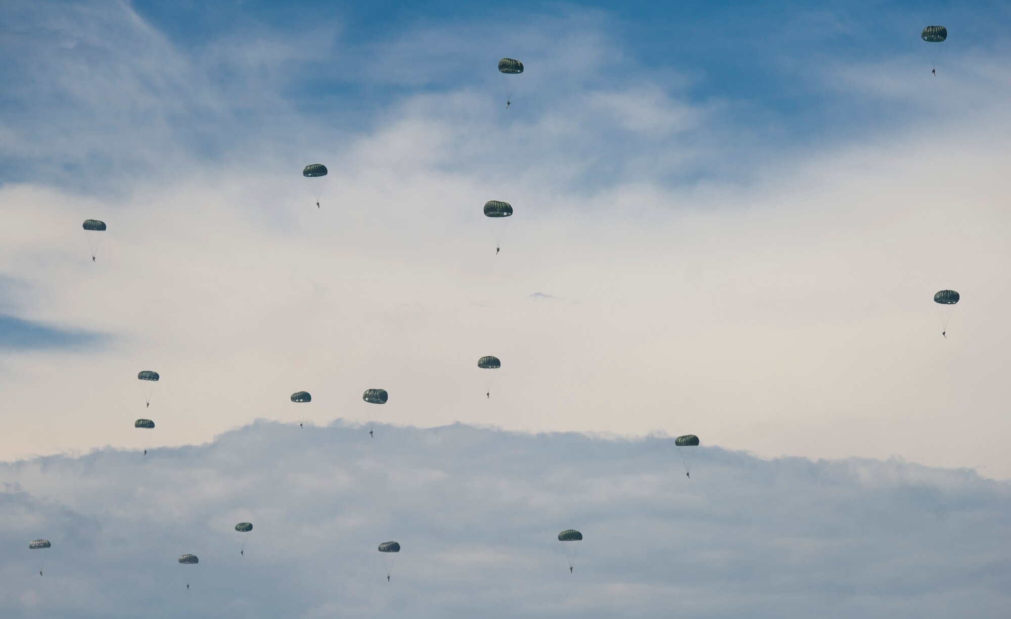 YOKOTA AIR BASE, Japan -- Several service members parachute to the ground after jumping out of a C-130 Hercules during the 2012 Japanese-American Friendship Festival at Yokota Air Base, Japan, Aug. 18, 2012.  (U.S. Air Force photo by Staff Sgt. Chad C. Strohmeyer)