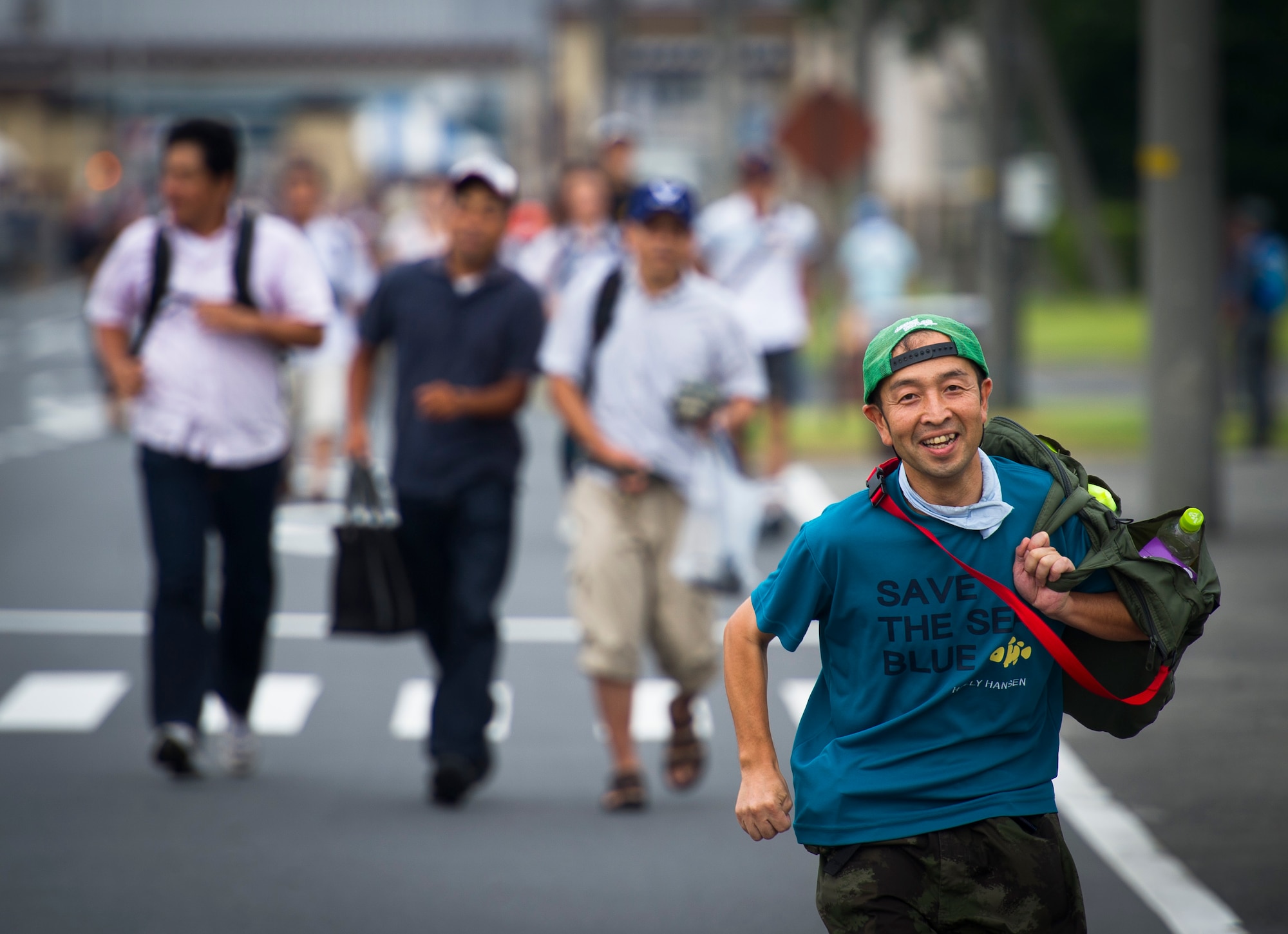 YOKOTA AIR BASE, Japan -- A Japanese man runs towards the festivities after Yokota Air Base opened its gates on the first day on the 2012 Japanese-American Friendship Festival Aug. 18, 2012.  Over a span of two days, approximately 178,000 patrons attended the event. (U.S. Air Force photo by Staff Sgt. Chad C. Strohmeyer)