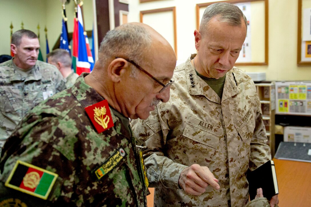 Afghan Gen. Sher Mohammad Karimi, left, chief of the General Staff of the Afghan army, and U.S. Marine Gen. John R. Allen, center, commander of U.S. and international forces in Afghanistan, meet at the International Security Assistance Force headquarters in Kabul, Afghanistan, Aug. 20, 2012.
