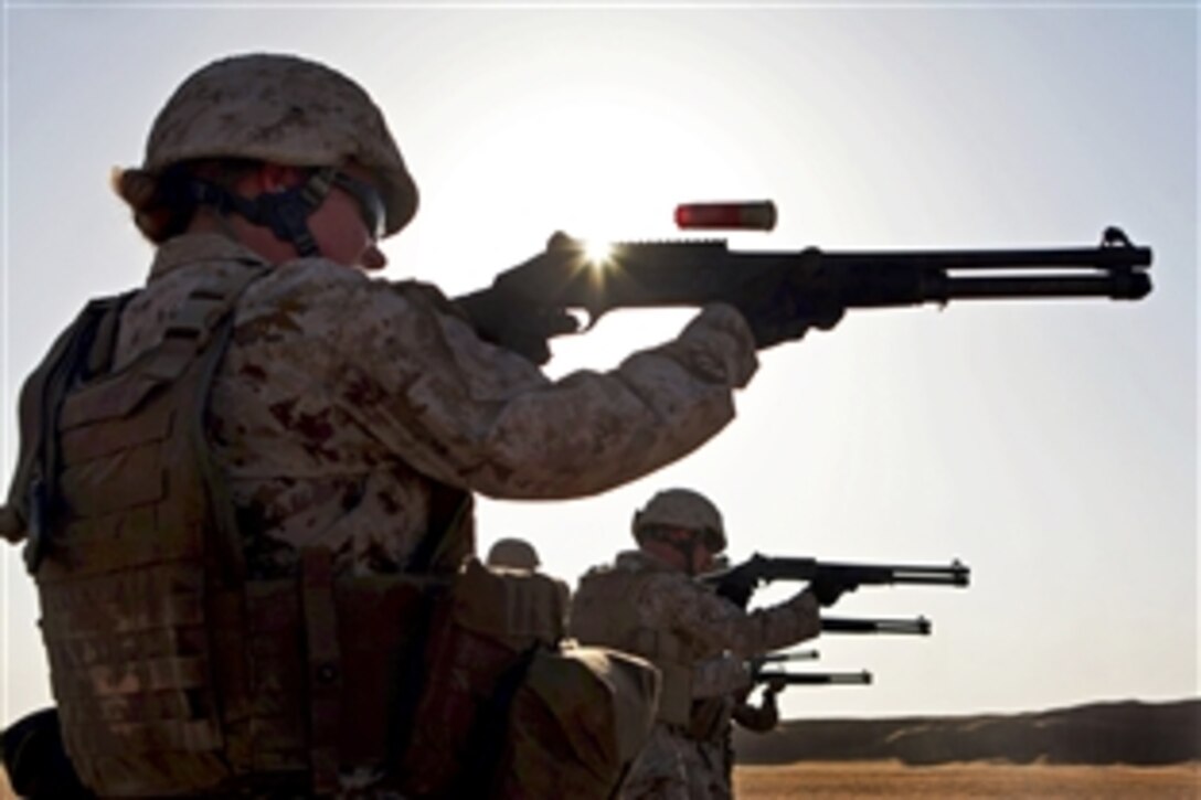 U.S. Marine Corps Sgt. Regina Smith fires an M1014 shotgun during a shotgun qualification on Udairi Range, Kuwait, Aug. 14, 2012. Smith, a radio supervisor, is assigned to Combat Logistics Battalion 24, 24th Marine Expeditionary Unit. The Marines are in Kuwait as part of the unit's sustainment training package, serving as a U.S. Central Command theater reserve force to support maritime security and theater security cooperations.