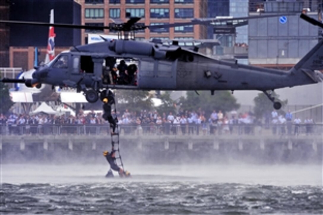 An HH-60 Pave Hawk helicopter conducts a mock water rescue during an aerial demonstration as a part of Air Force Week in New York, Aug. 19, 2012. The helicopter crew is assigned to 
the 106th Rescue Wing.