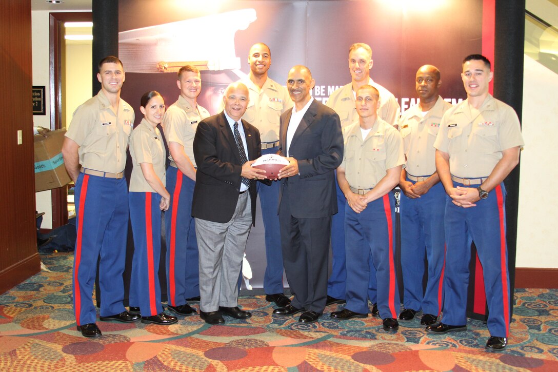 Officer selection officers from throughout 6th Marine Corps District, present a Marine football to "Tony" Dungy, a NBC football analyst,and former Indianapolis Colts head coach, during the 2012 Black Coaches Asociation conference in Orlando, Fla.
