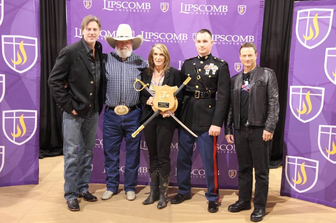 Major Harry K. Thompson, Commanding Officer of RS Nashville, presents Judy Seale with the Marine Corps Leadership award with country music legend Charlie Daniels and actor Gary Sinise at the Operation Yellow Ribbon concert in Nashville, TN March 6.