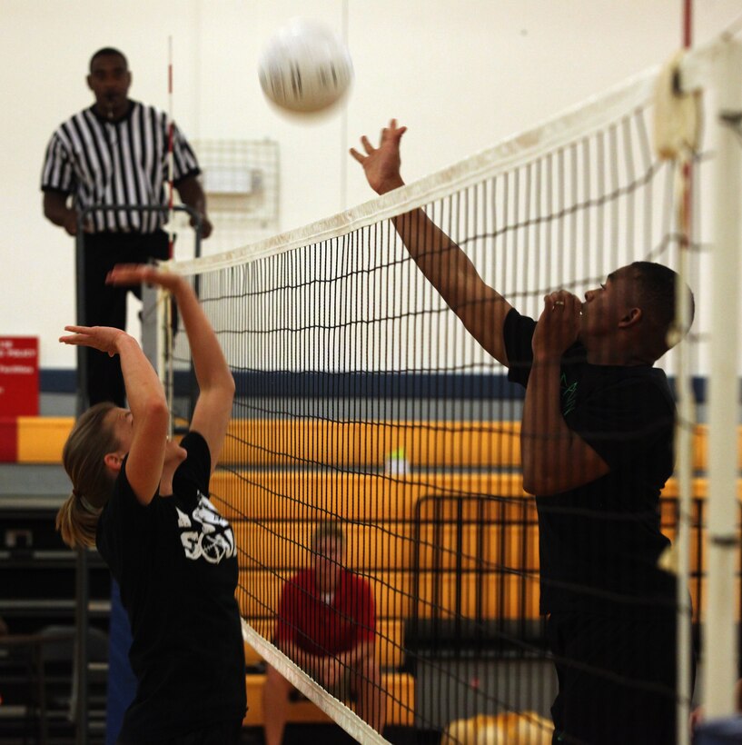 Steven Williams, player and coach for Spiked Punch, jumps up to hit the ball to Hitt Squad’s side of the court during the intramural volleyball championship tournament aboard Marine Corps Base Camp Lejeune Aug. 16. Spiked Punch won the first two of the best-of-three tournament to win the championship.