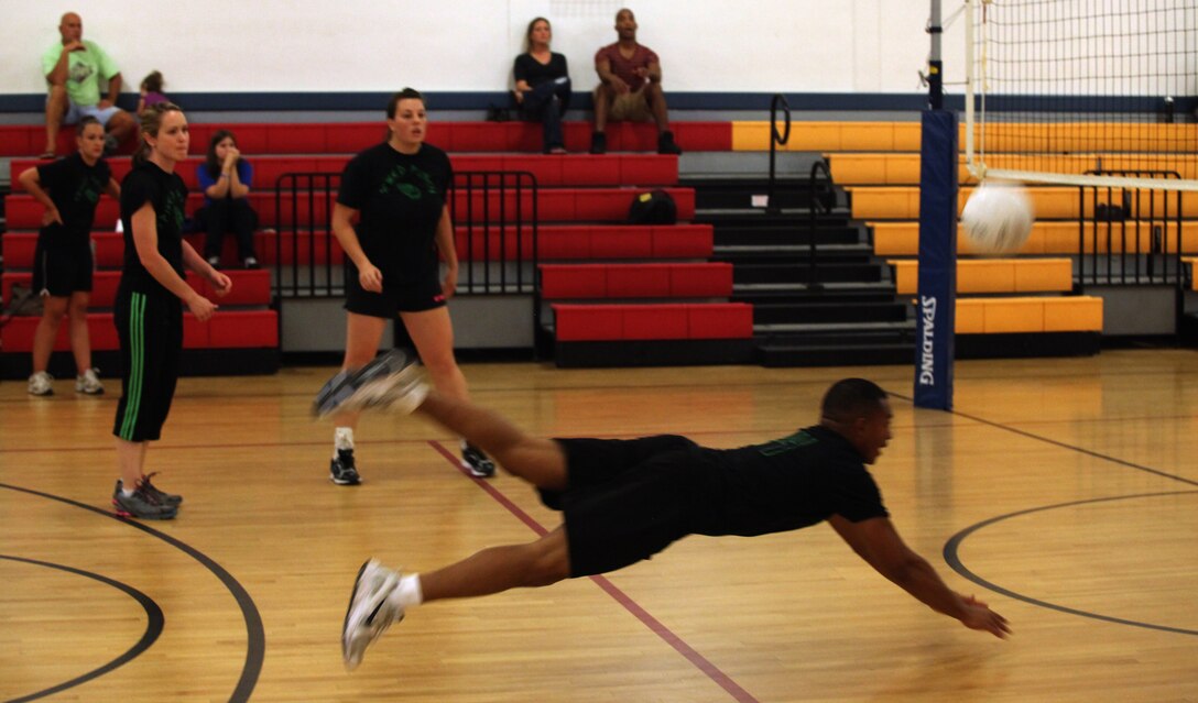Steven Williams, player and coach for Spiked Punch, dives for the ball during the intramural volleyball championship tournament aboard Marine Corps Base Camp Lejeune Aug. 16. Williams’ intensity was matched by the rest of his team as they took the best-of-three tournament to win the championship.