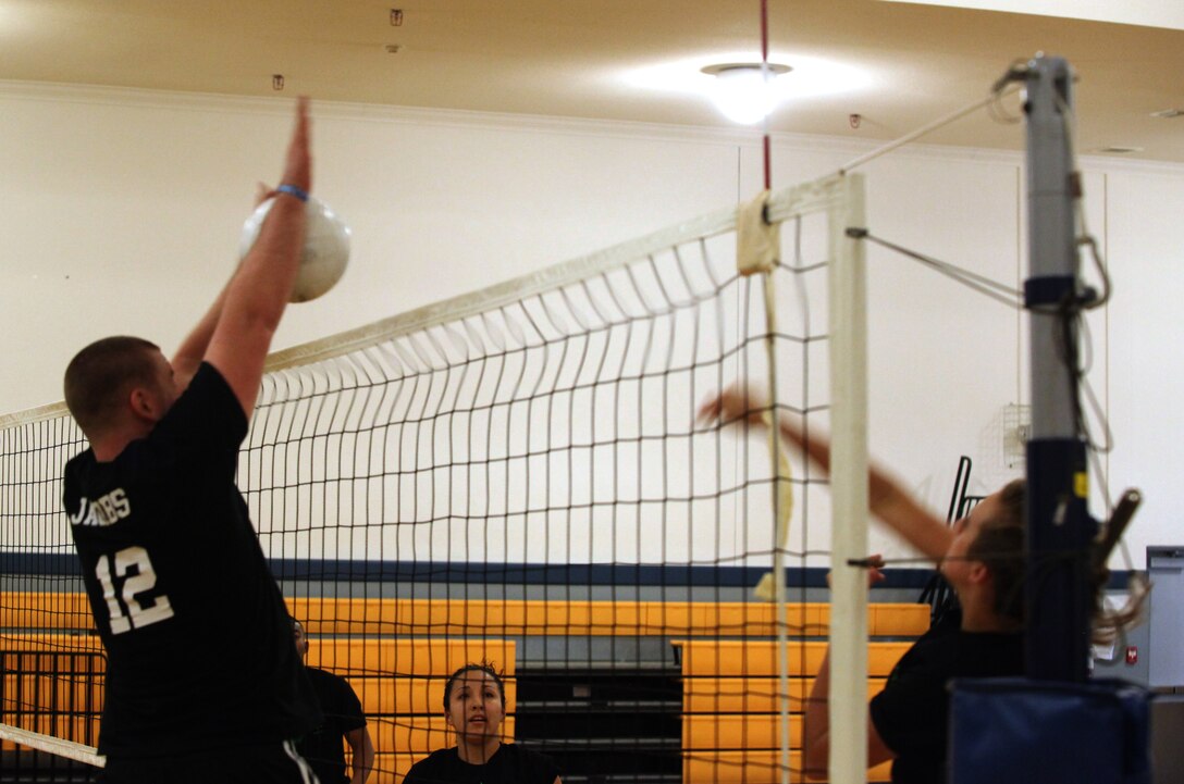 A player with Hitt Sqaud blocks a spike from Spiked Punch to score a point for his team during the intramural volleyball championship tournament aboard Marine Corps Base Camp Lejeune Aug. 16. Both teams made greats stops to turn the momentum of the game throughout the tournament and both matches were hard-fought.