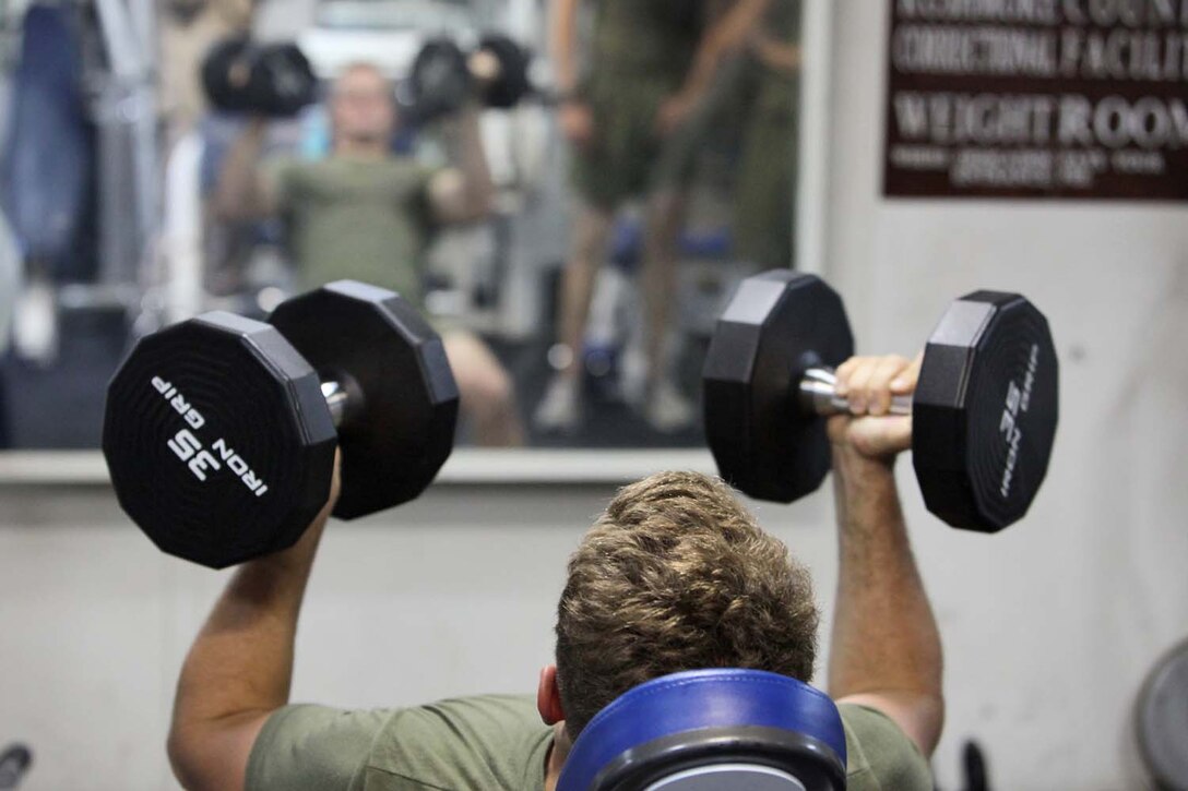 Lance Cpl. Christopher Moore, field artilleryman, Battery B, Battalion Landing Team 3/5, 15th Marine Expeditionary Unit, lifts weights inside one of three fitness rooms aboard the USS Rushmore, Aug. 18. Marines from the MEU exercise regularly during the unitâ€™s final training evolution, Certification Exercise. CERTEX differs from previous exercises because Marines and Sailors react to unknown scenarios using the Marine Corpsâ€™ Rapid Response Planning Process.