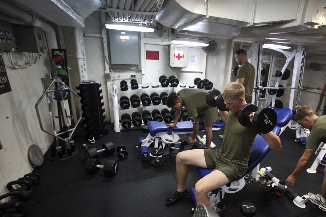 Marines from Battery B, Battalion Landing Team 3/5, 15th Marine Expeditionary Unit, lift weights inside one of three fitness rooms aboard the USS Rushmore, Aug. 18. Marines from the MEU exercise regularly during the unitâ€™s final training evolution, Certification Exercise. CERTEX differs from previous exercises because Marines and Sailors react to unknown scenarios using the Marine Corpsâ€™ Rapid Response Planning Process.