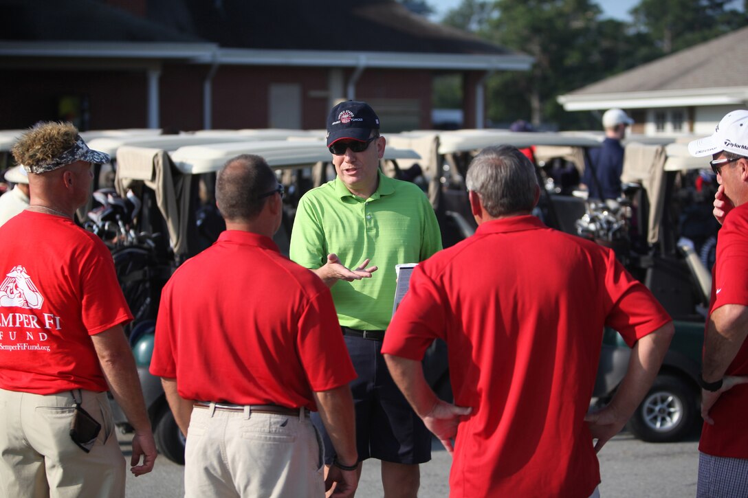 Navy Capt. Francisco R. Leal, the commanding officer of 2nd Dental Battalion, 2nd Marine Logistics Group, speaks to some volunteers with the Injured Marine Semper Fi Fund during a battalion golf tournament aboard Camp Lejeune, N.C., Aug. 17, 2012. The tournament was part of the Navy Dental Corps’ 100th anniversary celebration.  The command took the opportunity to build camaraderie and also collect money to help wounded warriors. The sailors raised approximately $1700 to donate to the fund. 
