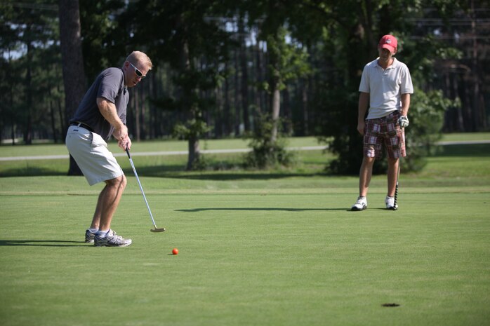 Navy Lt. James A. Shaul, a dental officer with 2nd Dental Battalion, 2nd Marine Logistics Group, hits a golf ball during a tournament aboard Camp Lejeune, N.C., Aug. 17, 2012. The tournament was part of the Navy Dental Corps’ 100th anniversary celebration.  The battalion’s leadership took the opportunity to build camaraderie and also collect money to help wounded warriors. The sailors raised approximately $1700 to donate to the fund. 