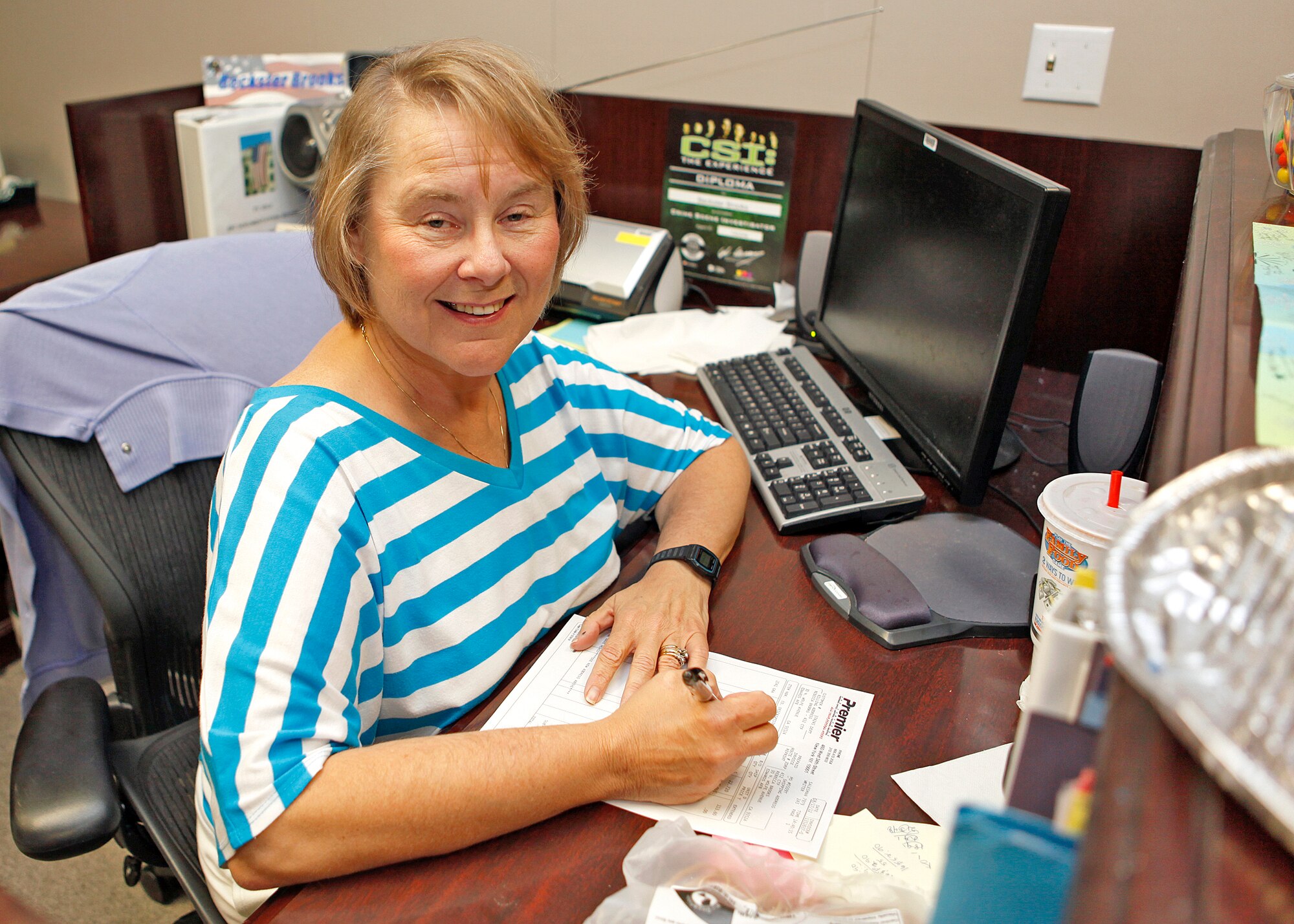 Becki Brooks, an administrative assistant with the 452nd Flight Test Squadron, poses for a picture at her workplace after  recieving a kidney from her husband in April 10, 2012. Kirt Brooks, her husband, donated one of his kidneys to her as part of a donor transplant program. (U.S. Air Force photo by Jet Fabara)