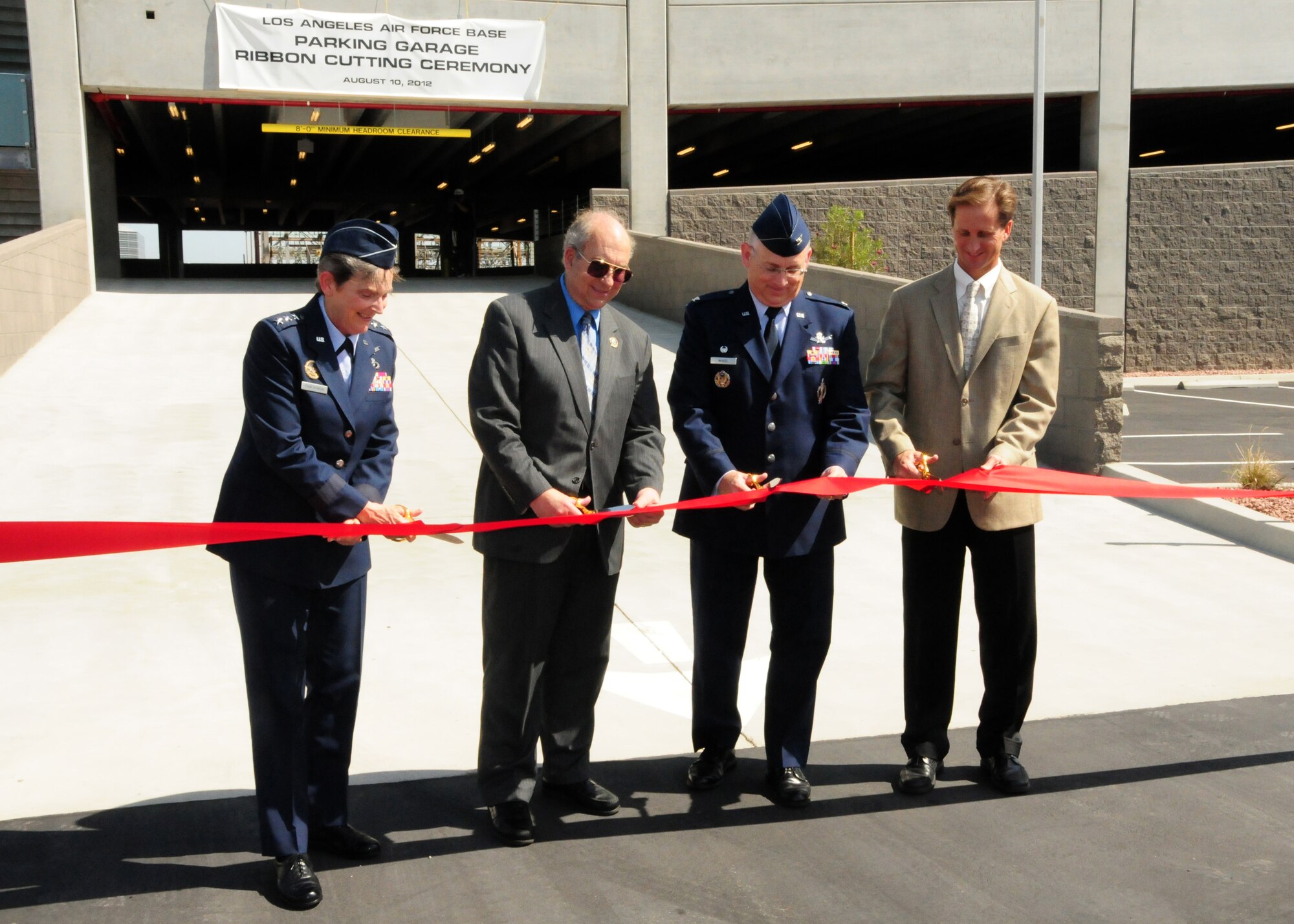 Lieutenant General Ellen Pawlikowski, Space and Missile Systems commander, is joined by El Segundo Mayor Carl Jacobson; Col. Sam McNiel, 61st Air Base Group commander; and Jeff Harper, Harper Construction president, in cutting the ribbon to open Los Angeles Air Force Base’s new parking garage. The new garage, opened on Aug. 10, adds more than 200 new parking spots. (Photo by Jim Gordon)