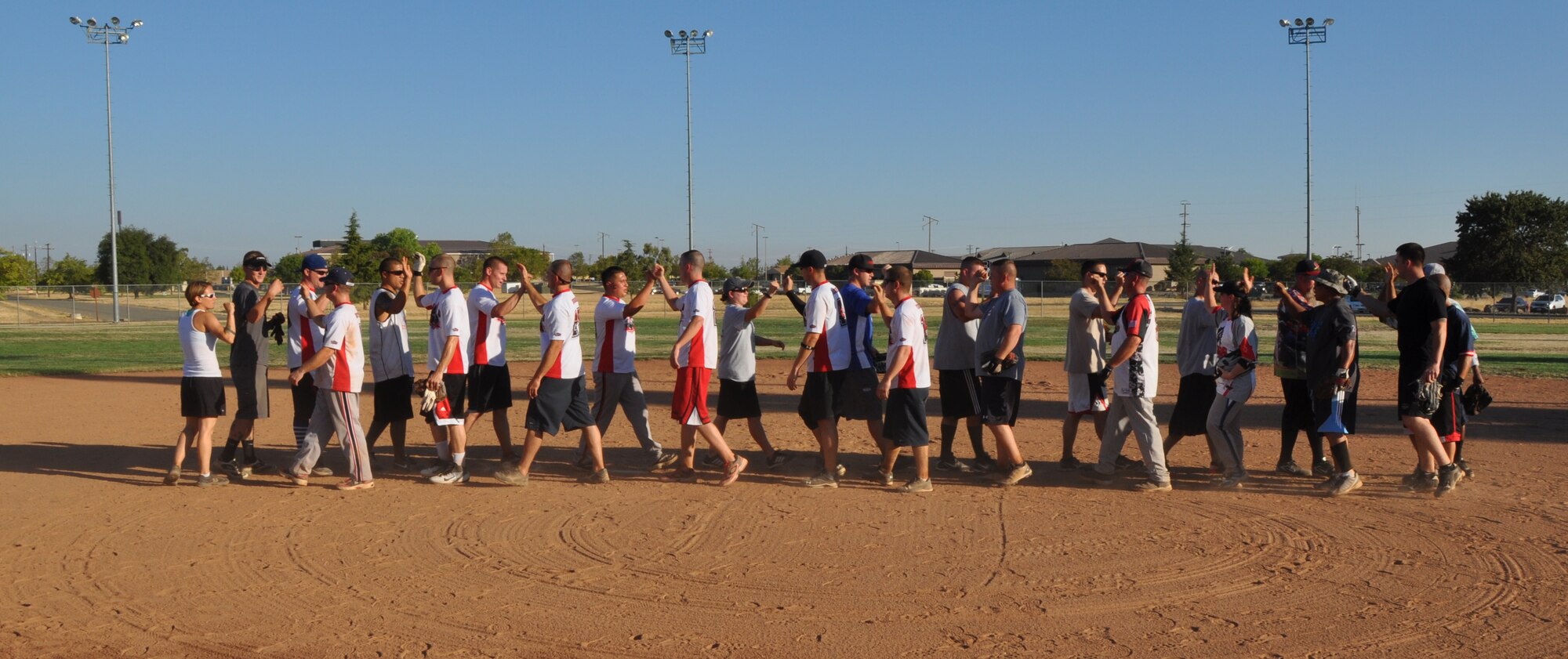 Members of the 9th Maintenance Squadron and 9th Munitions Squadron congratulate each other at the end of Beale’s Intramural Softball Championships at Beale Air Force Base, Calif., Aug. 16, 2012. The 9th MXS defeated the 9th MUNS with a 10-9 victory. (U.S Air Force photo by Staff Sgt. Robert M. Trujillo)