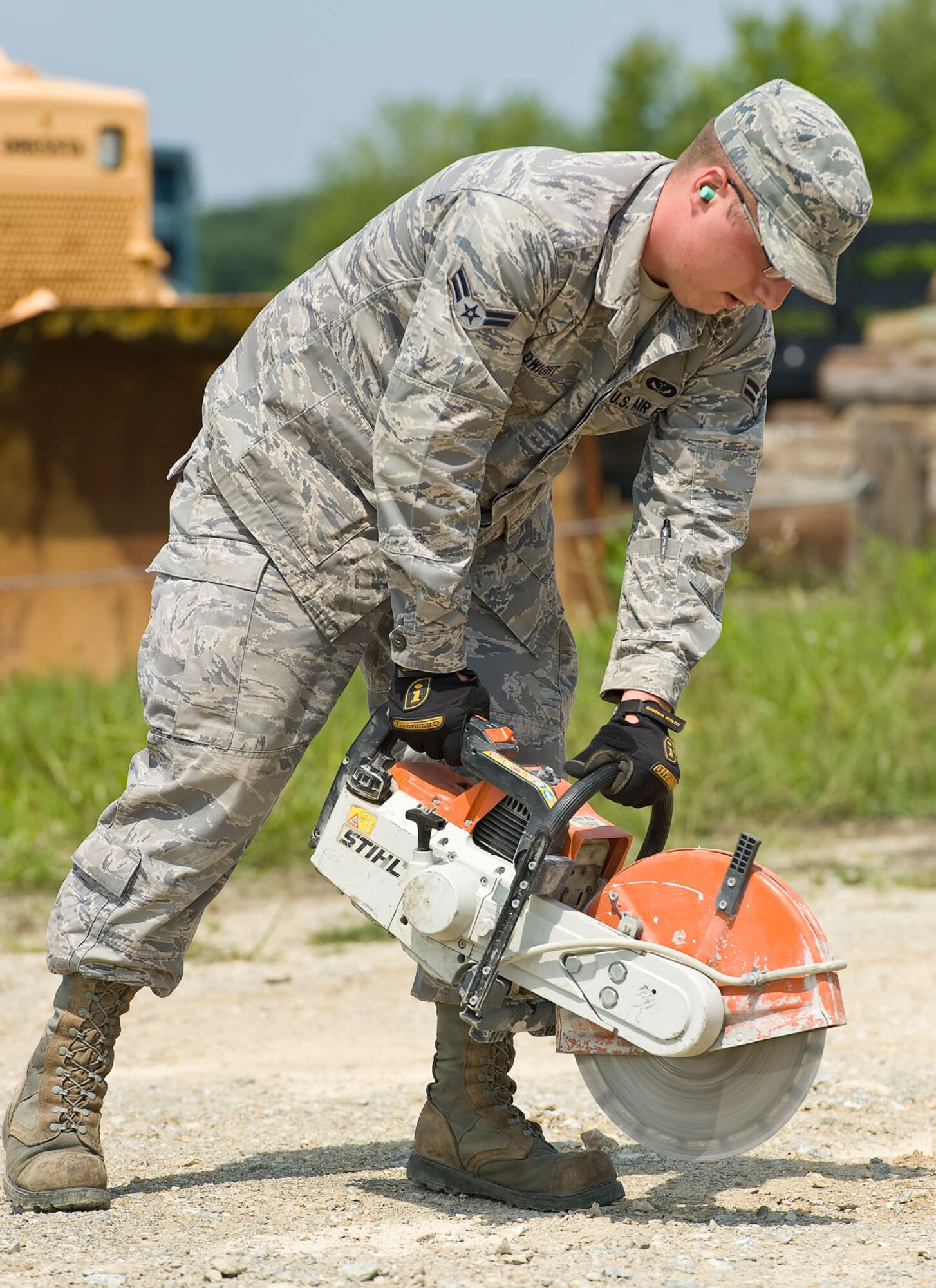 Airman 1st Class Patrick Dwight, a heavy-equipment operator with the 436th Civil Engineer Squadron, simulates cutting into asphalt Aug. 21, 2012, at Dover Air Force Base, Del. A simulated gas leak and repair was part of the Aug. 20-22 Major Accident Response Exercise, held to test Team Dover’s ability to respond to threats and emergencies. Dover AFB partnered with members of the local community during the MARE to strengthen cooperation and communication between emergency agencies. (U.S. Air Force photo by Roland Balik)