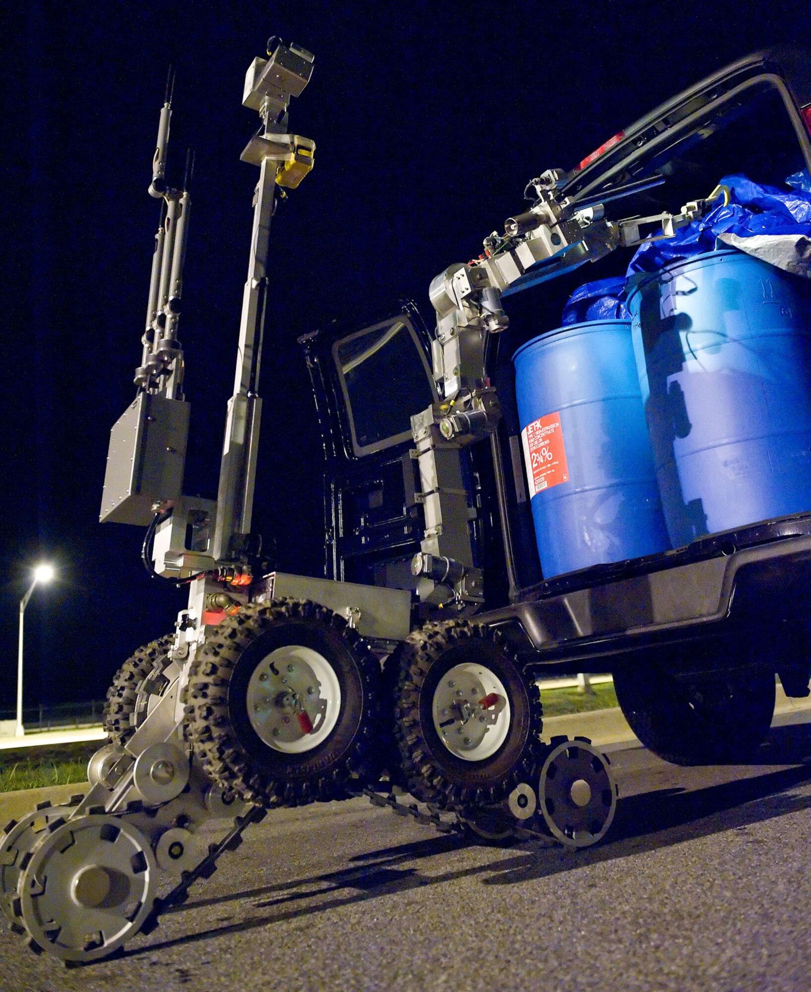 The Andros F6A Explosive Ordnance Disposal unmanned robot remotely inspects contents of a vehicle at the Commercial Vehicle Inspection Facility Aug. 20, 2012, at Dover Air Force Base, Del. From a quarter-mile away, EOD personnel controlled the robot movements as part of the Aug. 20-22 Major Accident Response Exercise, held to test Team Dover's readiness to respond to threats and emergencies. Dover AFB partnered with members of the local community during the MARE to strengthen cooperation and communication between emergency agencies. (U.S. Air Force photo by Roland Balik)