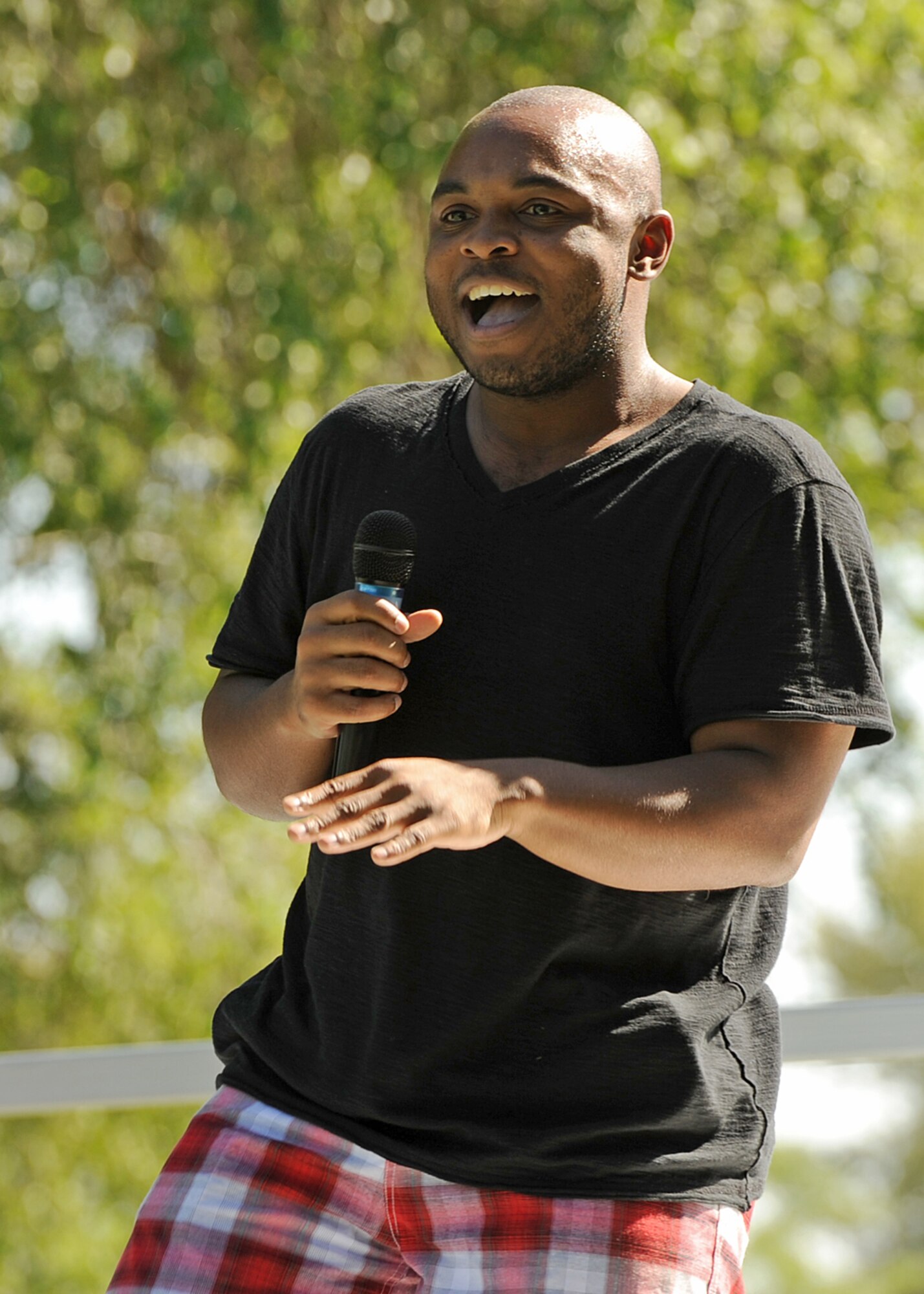 Jevar Bailey, 92nd Force Support Squadron Funspot staff, sings “Hey Soul Sister” during the Air Mobility Command Icon competition in Miller Park at Fairchild Air Force Base, Wash., Aug. 17, 2012. Bailey placed second place in the competition. (U.S. Air Force photo by Staff Sgt. Michael Means)