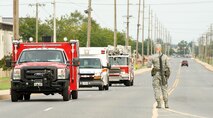 Airman 1st Class Christopher Anderson, an integrated base defense augmentee from the 436th Civil Engineer Squadron, allows emergency vehicles through the entry control point near the North Gate Aug. 20, 2012, at Dover Air Force Base, Del. A simulated single-vehicle incident at the north electrical substation was part of the Aug. 20-22 Major Accident Response Exercise, held to test Team Dover's ability to respond to threats and emergencies. Dover AFB partnered with members of the local community during the MARE to strengthen cooperation and communication between emergency agencies. (U.S. Air Force photo by Roland Balik)