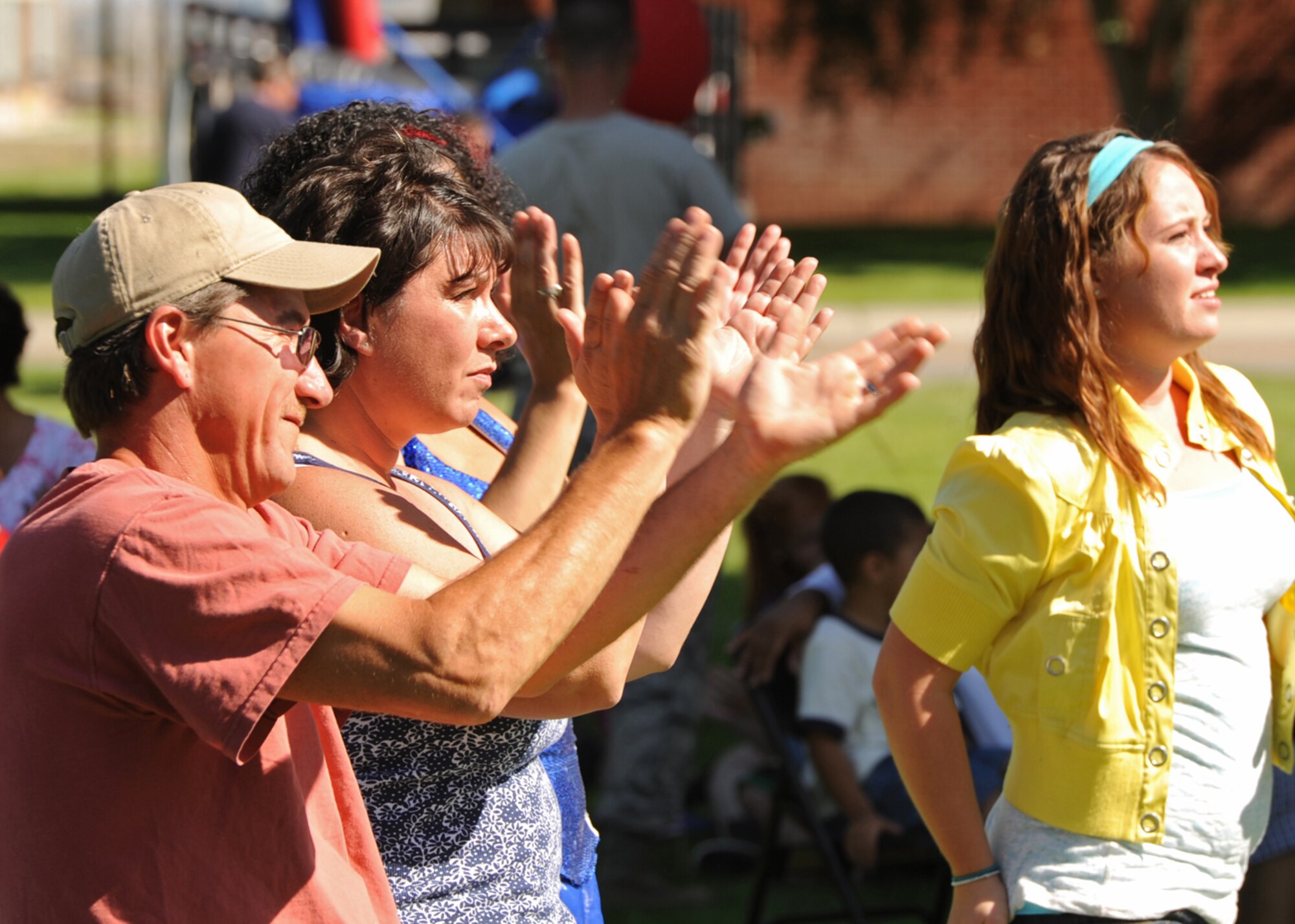 Members of Team Fairchild cheer on participants of the Air Mobility Command Icon competition during the base picnic in Miller Park at Fairchild Air Force Base, Wash., Aug. 17, 2012.  (U.S. Air Force photo by Staff Sgt. Michael Means)