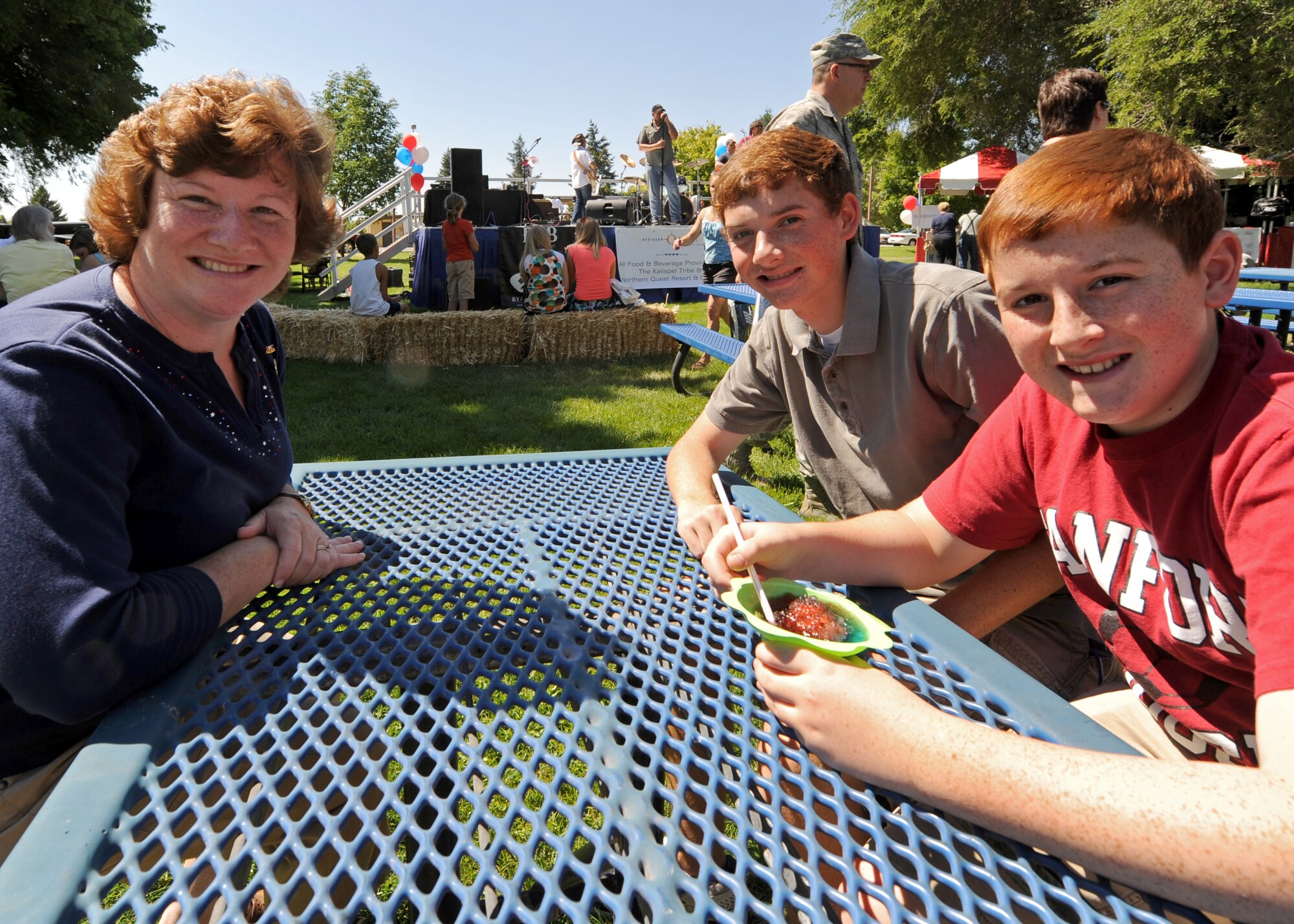Mrs. Jill Newberry, spouse of Col. Brian Newberry, 92nd Air Refueling Wing commander, spends time with their kids, Mark and Matthew, at the base picnic in Miller Park at Fairchild Air Force Base, Wash., Aug. 17, 2012. The picnic was host to a variety of events including bouncing castles, a rappelling wall, a shirt painting booth, the Air Mobility Command Icon competition, free food and many other booths and activities. (U.S. Air Force photo by Staff Sgt. Michael Means)