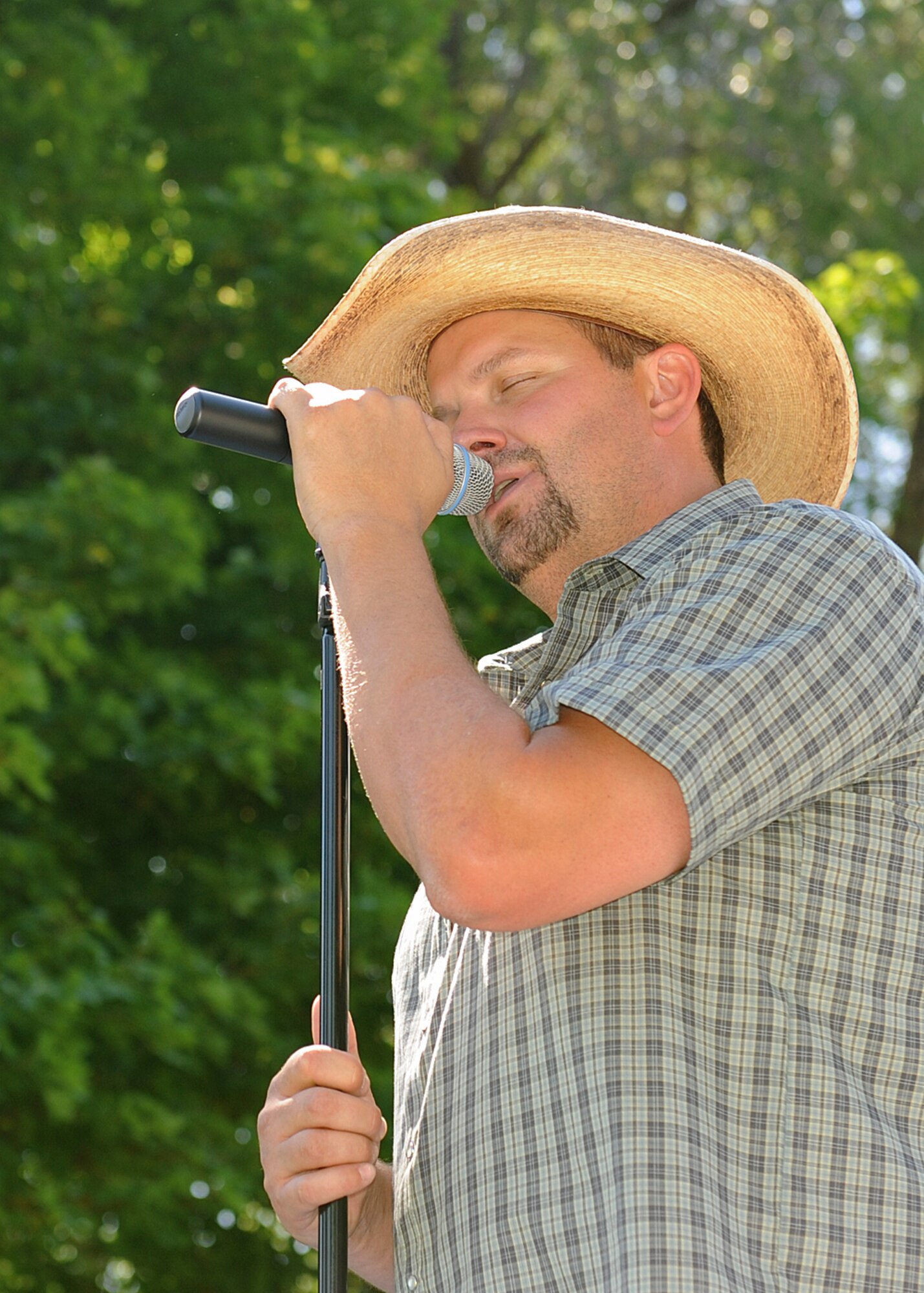 Ryan Larsen, The Ryan Larsen Band vocalist, sings for members of Team Fairchild during the base picnic at Miller Park in Fairchild Air Force Base, Wash., Aug. 17, 2012.  (U.S. Air Force photo by Staff Sgt. Michael Means)
