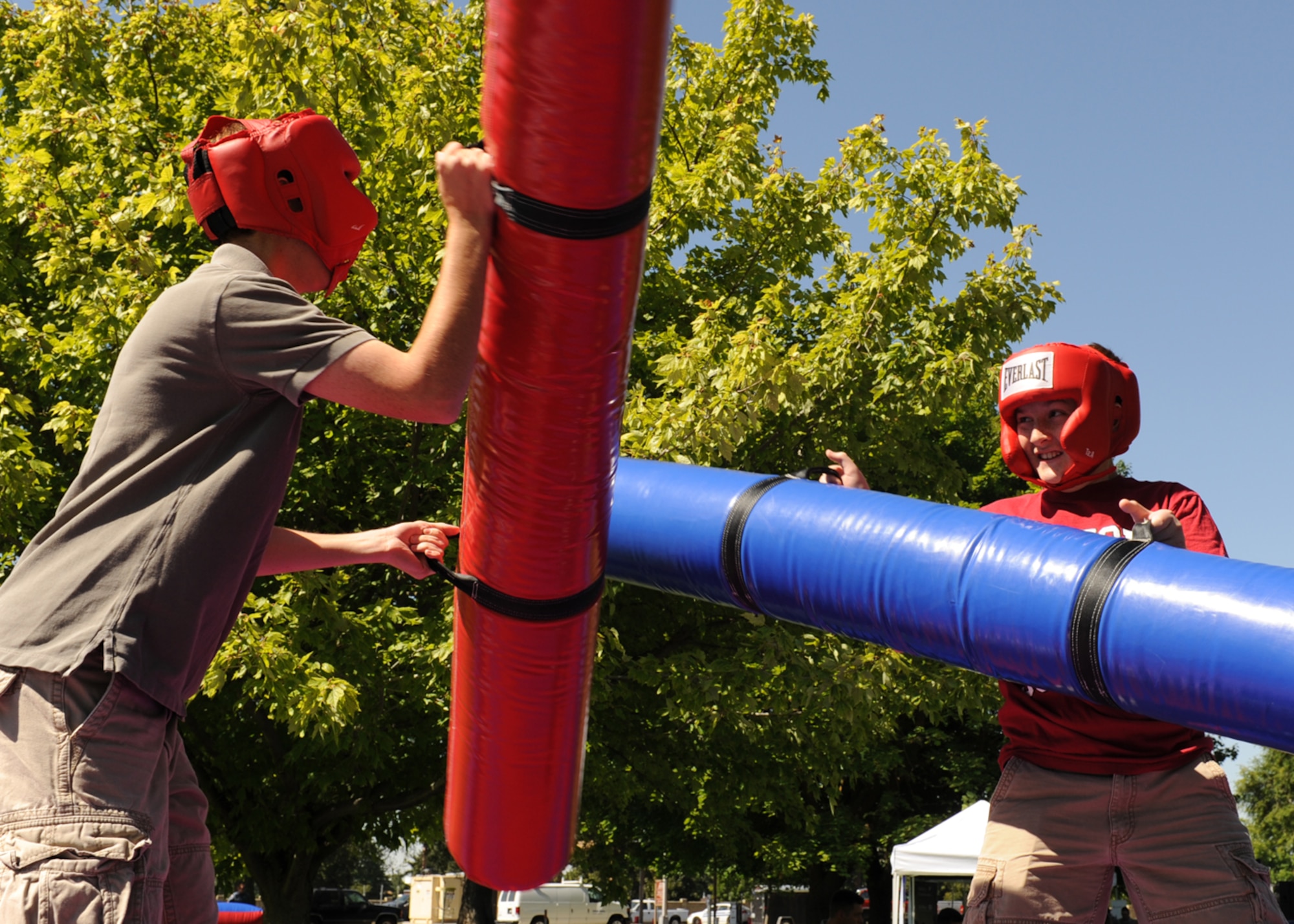 Mark and Matthew Newberry, sons of Col. Brian Newberry, 92nd Air Refueling Wing commander, joust at the base picnic in Miller Park at Fairchild Air Force Base, Wash., Aug. 17, 2012. The picnic was host to a variety of events including bouncing castles, a rappelling wall, a shirt painting booth, the Air Mobility Command Icon competition, free food and many other booths and activities. (U.S. Air Force photo by Staff Sgt. Michael Means)