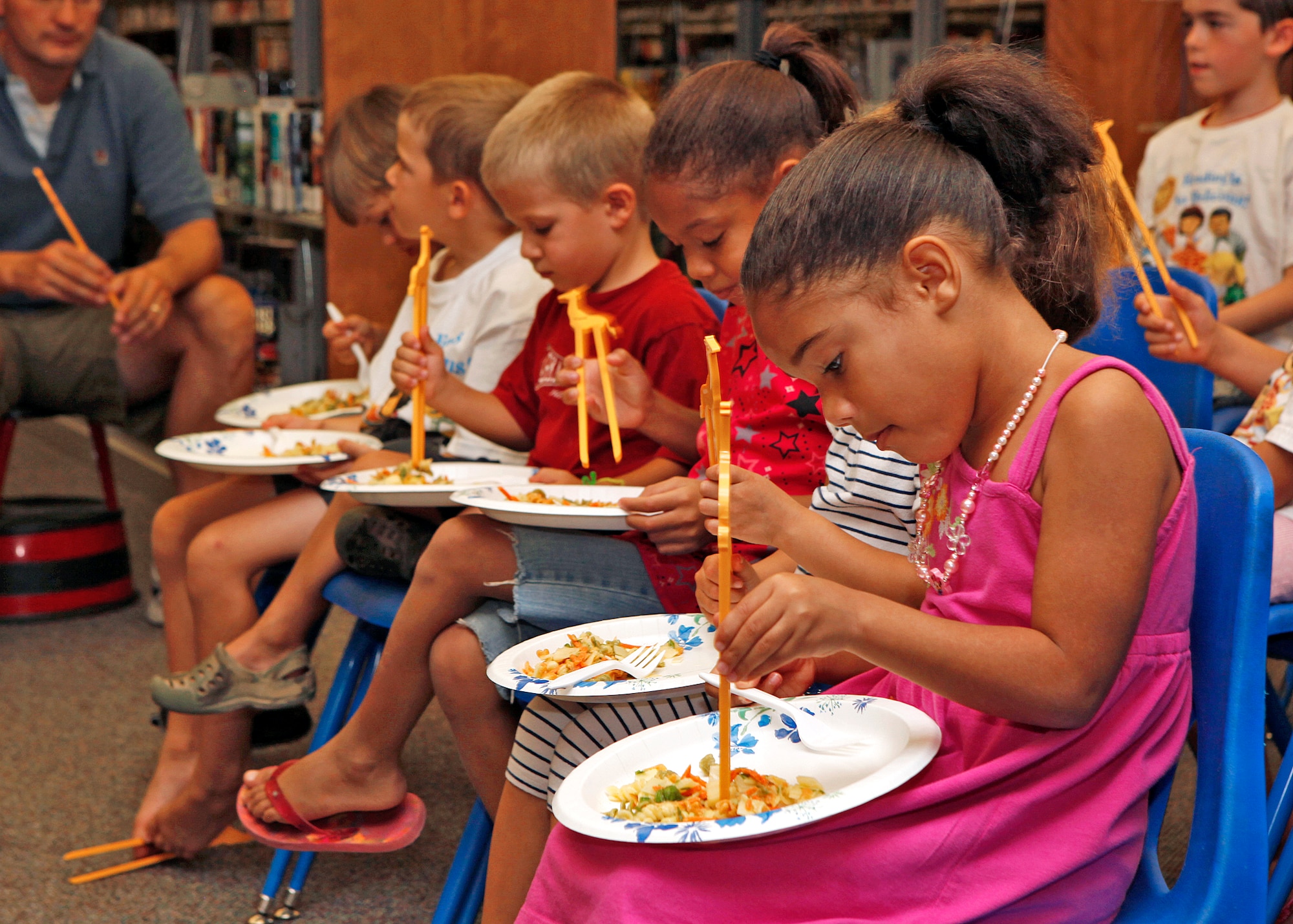 Braina Nash (far right) was one of the many kids who participated in the summer reading program finale at the Edwards Library Aug. 17. This year's theme for the reading program was "Reading is so Delicious." Approximately 50 kids showed up to the learning event. (U.S. Air Force photo by Jet Fabara)