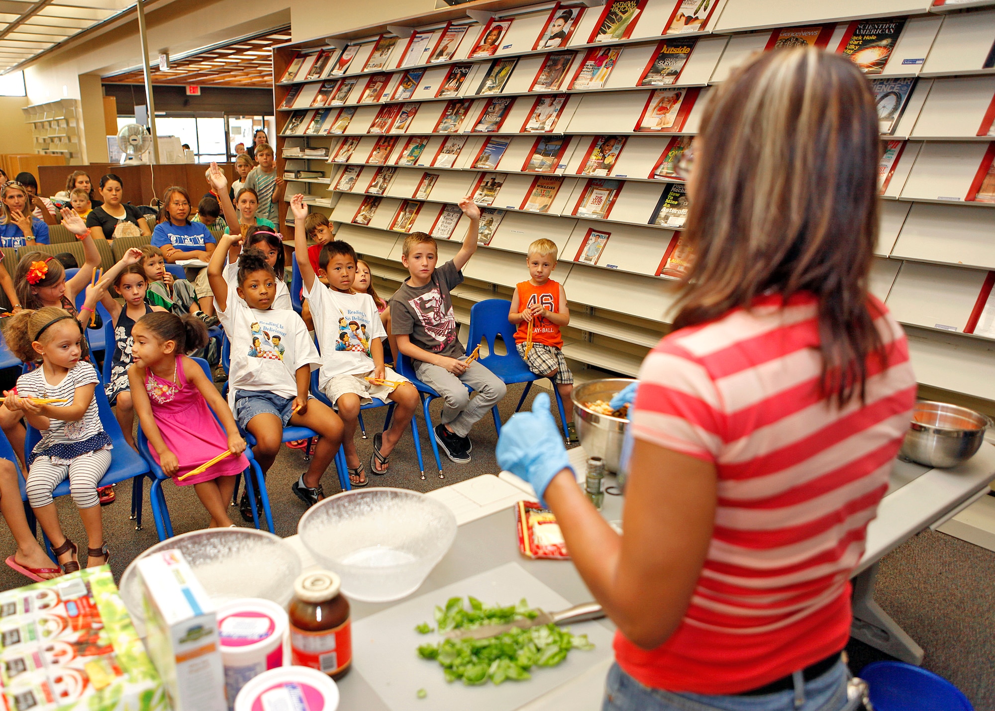 Approximately 50 kids attended the final event to the summer reading program, themed "Reading is so Delicious," which ended Aug. 17 at the Main Library. The program kicked off June 8 and was used as a way to bring reading awareness to the Edwards community. As part of the finale, the Health and Wellness Center presented a food demonstration as a way of complimenting this year's theme. (U.S.  Air Force photo by Jet Fabara)