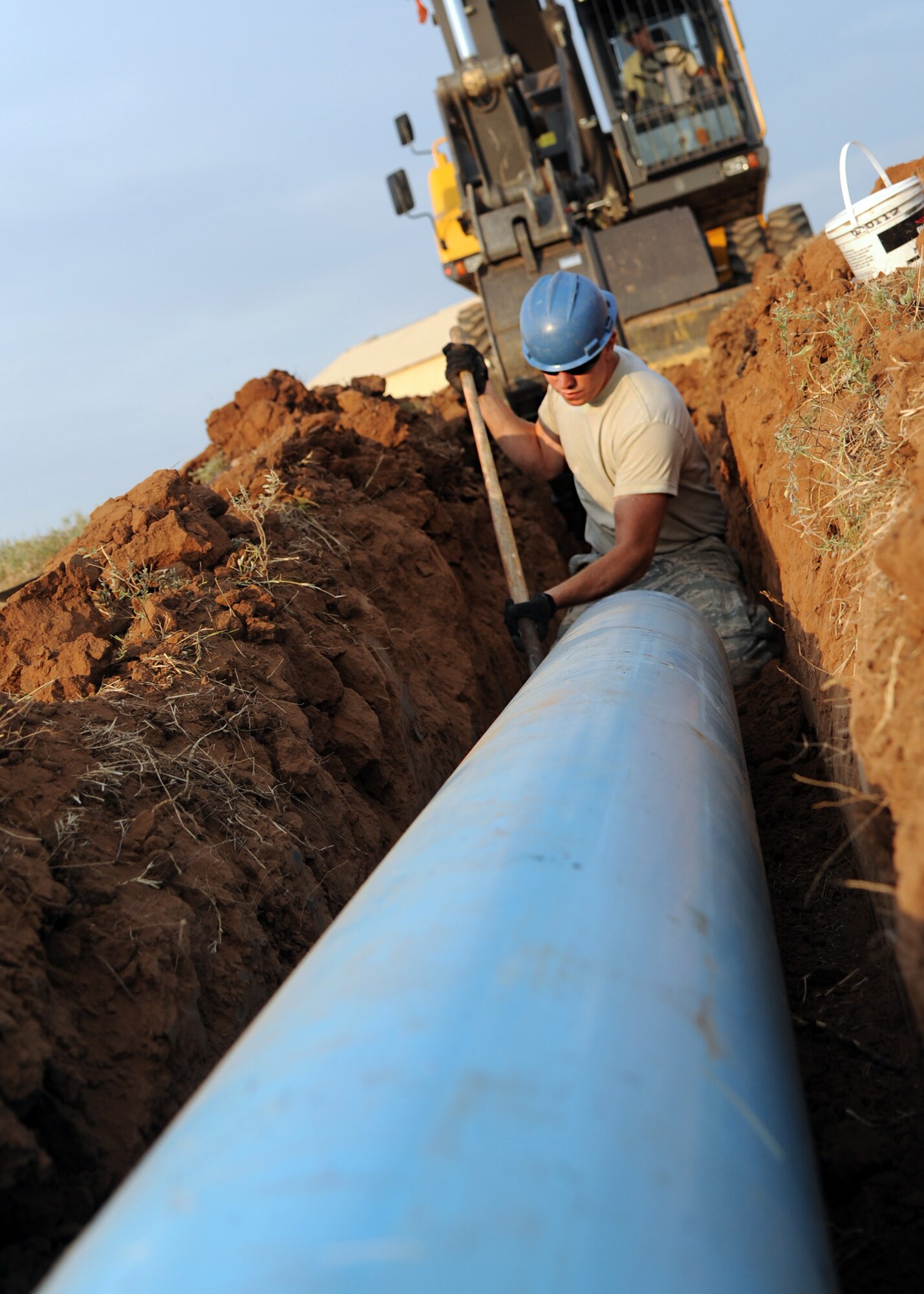 ALTUS AIR FORCE BASE, Okla. – Airman 1st Class Michael Wiggins, 97th Civil Engineer Squadron water and fuel systems maintenance apprentice, prepares a pipe for installation behind a tanker fuel yard, Aug. 14, 2012. The 97th CES is working on a raw water irrigation project which satisfies a cost-conscious culture. The non-potable irrigation water will be used to water the Windy Trails Golf Course, saving the base around $48,000 on utility cost per year and saving the City of Altus around $12,000 on operational cost per year. (U.S. Air Force photo by Airman 1st Class Klynne Pearl Serrano / 97th Air Mobility Wing / Released)