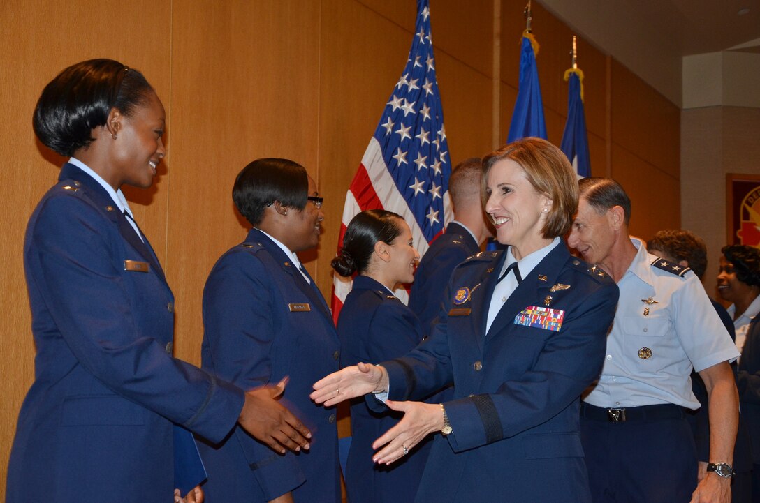 Maj. Gen. Kimberly A. Siniscalchi, assistant Air Force surgeon general, Medical Force Development, Nursing Services, shakes hands with 2nd Lt. Stephanie Lord, one of the 12 Air Force Nursing Residency Program graduates following their graduation ceremony Aug. 20 at San Antonio Military Medical Center.(U.S. Air Force photo by Lori A. Newman)