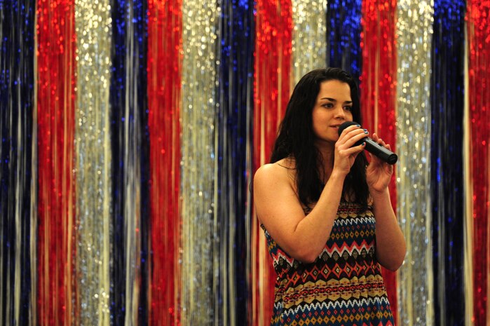 Georgette Chavis, from the 628th Medical Group, sings during the Air Mobility Command Icon Aug. 16, 2012 at Joint Base Charleston – Air Base, S.C. Chavis took third place in the contest and received $200. Each major installation within AMC is conducting a base-level AMC Icon contest. The first place winner from each of the installations will compete in the command finals Oct. 25, 2012 at Scott Air Force Base, Ill. Sabrina Begay, spouse of Staff Sgt. Marc Begay from the 437th Aircraft Maintenance Squadron, will represent JB Charleston in the AMC finals (U.S. Air Force photo/ Staff Sgt. Nicole Mickle)