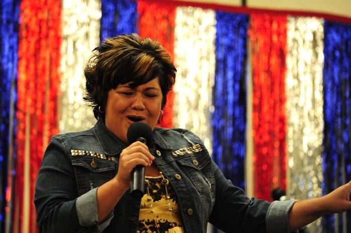 Sabrina Begay, spouse of Staff Sgt. Marc Begay from the 437th Aircraft Maintenance Squadron, sings during the Air Mobility Command Icon Aug. 16, 2012 at Joint Base Charleston – Air Base, S.C. Each major installation within AMC is conducting a base-level AMC Icon contest. The first place winner from each of the installations will compete in the command finals Oct. 25, 2012 at Scott Air Force Base, Ill. Begay won first place in the Charleston’s AMC Icon and received $500 and will represent JB Charleston in the command finals.  (U.S. Air Force photo/ Staff Sgt. Nicole Mickle)