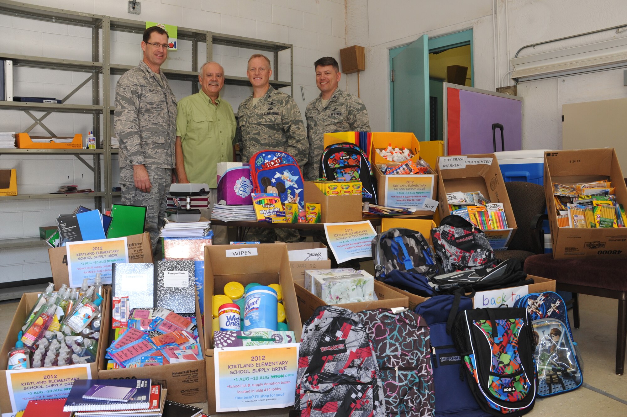 KIRTLAND AFB, N.M. -- From left, Col. Urban Gillespie, principal Peter Espinosa, Col. Mike Moran and Col. John Anttonen appear with donated school supplies for Kirtland Elementary School. (Photo by Senior Airman Matt Johnson)