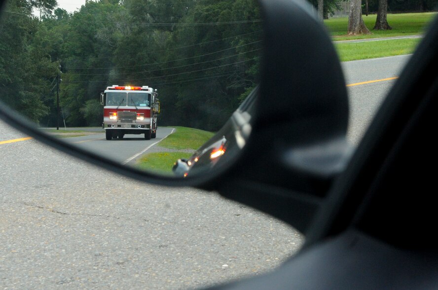 Firefighters from the 2nd Civil Engineer Squadron respond to a call on Barksdale Air Force Base, La., Aug. 21. All vehicles must pull over to the side of the road to allow emergency vehicles to pass, allowing emergency personnel to respond to calls in a timely manner. (U.S. Air Force photo/Airman 1st Class Micaiah Anthony)(RELEASED)