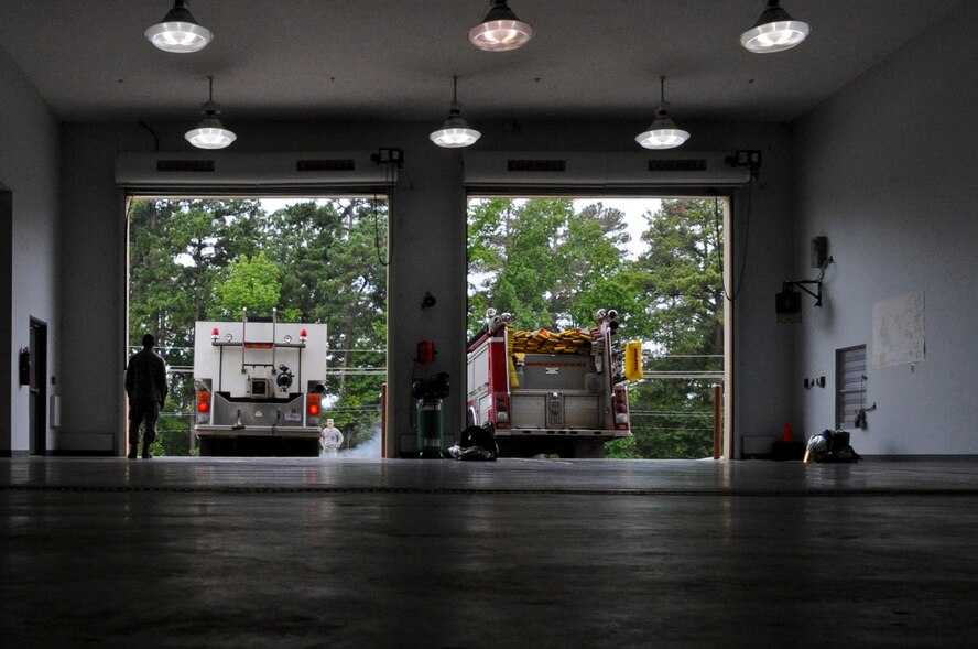 Firefighters from the 2nd Civil Engineer Squadron guide a fire truck into the fire station on Barksdale Air Force Base, La., Aug. 21, before responding to an exercise. After the truck was in the station, the firefighters donned their gear and took the other fire truck to respond to the call. (U.S. Air Force photo/Airman 1st Class Micaiah Anthony)(RELEASED)